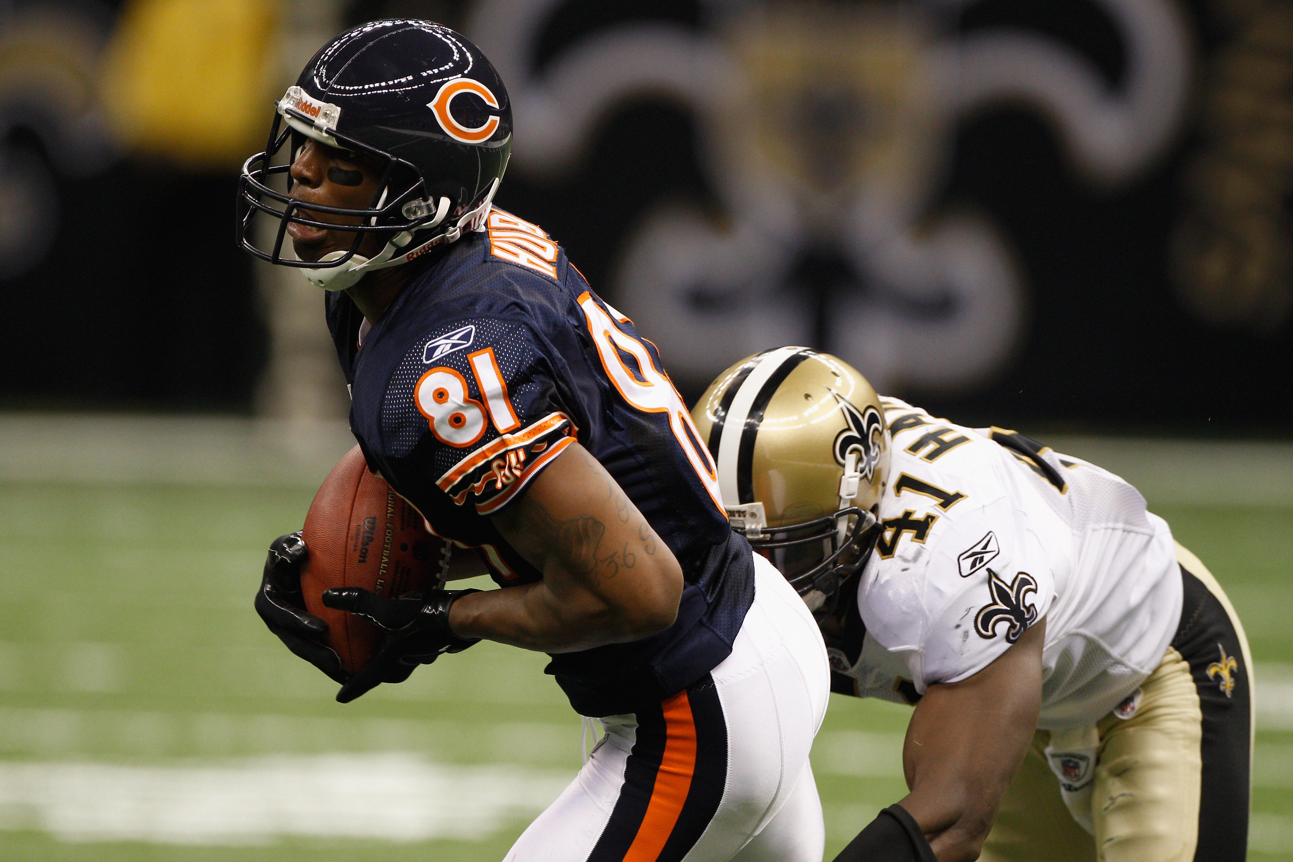 Sam Hurd of the Chicago Bears catches a pass over Roman Harper of the New Orleans Saints on September 18, 2011 in New Orleans, Louisiana.
