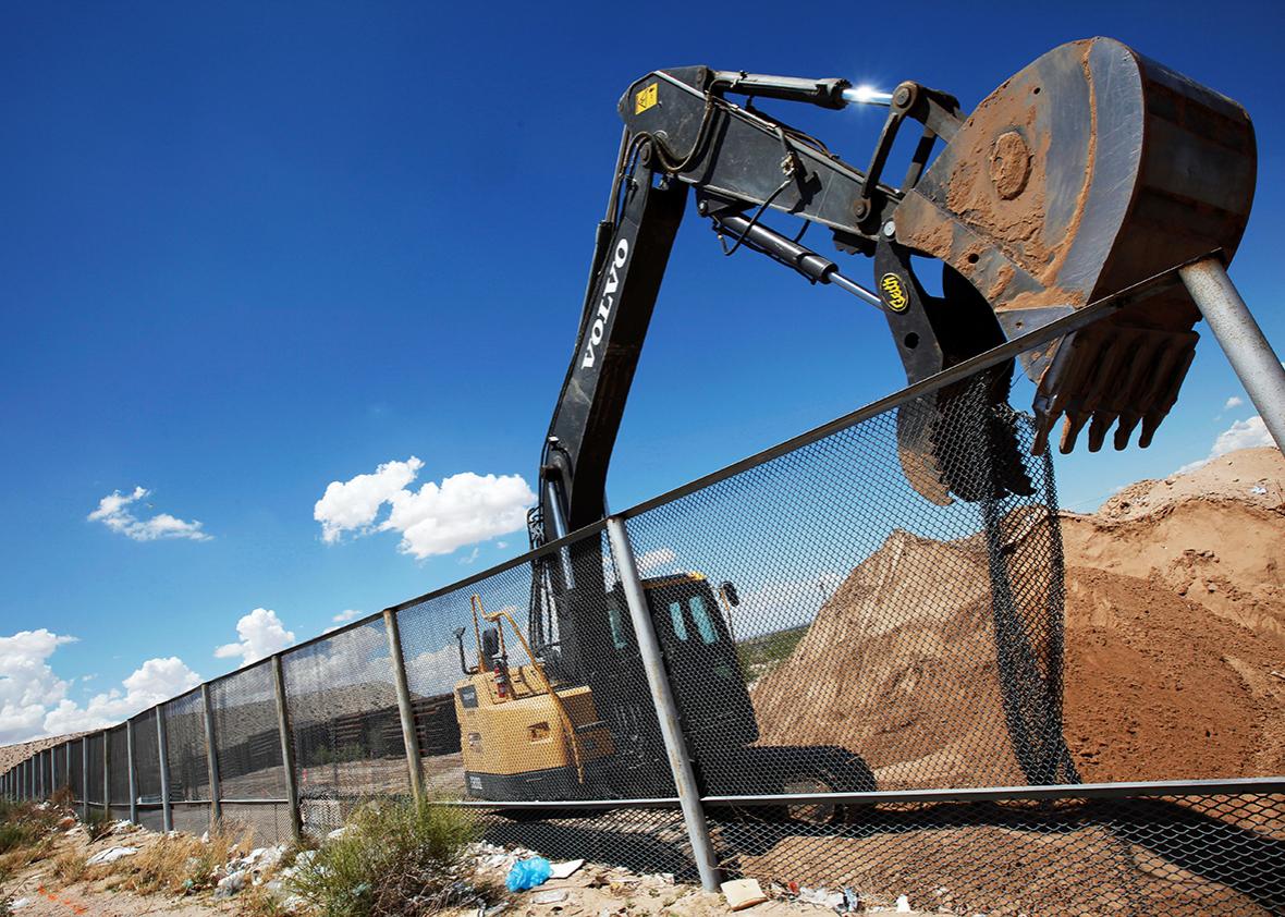 An excavator removes a fence, which will be replace by a section of the U.S.-Mexico border wall at Sunland Park, U.S. opposite the Mexican border city of Ciudad Juarez, Mexico, August 26, 2016. 