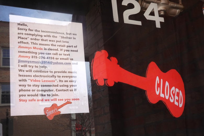 WOODSTOCK, ILLINOIS - APRIL 06: A sign on the front door of Jimmy's Music explains why the business is closed on April 06, 2020 in Woodstock, Illinois. Most of the small businesses in the town remain closed after the governor ordered residents to shelter-in-place in an attempt to curtail the spread of the coronavirus. Woodstock, about 50 miles northwest of Chicago with a population of around 25,000, was once home to filmmaker Orson Welles and was the setting for the 1992 movie Groundhog Day. (Photo by Scott Olson/Getty Images)