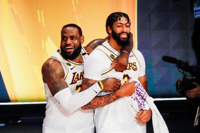 LeBron James embraces Anthony Davis on the court, both smiling