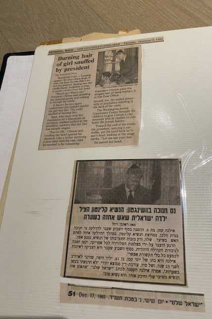 Page of a family album containing two newspaper article cutouts.