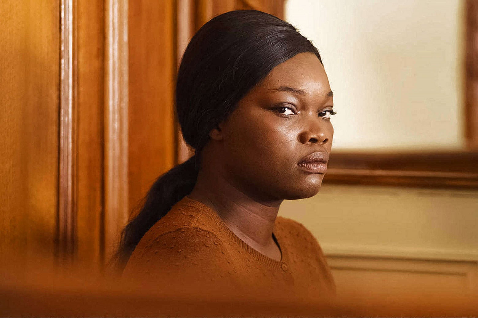 Close up of a woman on the stand in a courtroom.