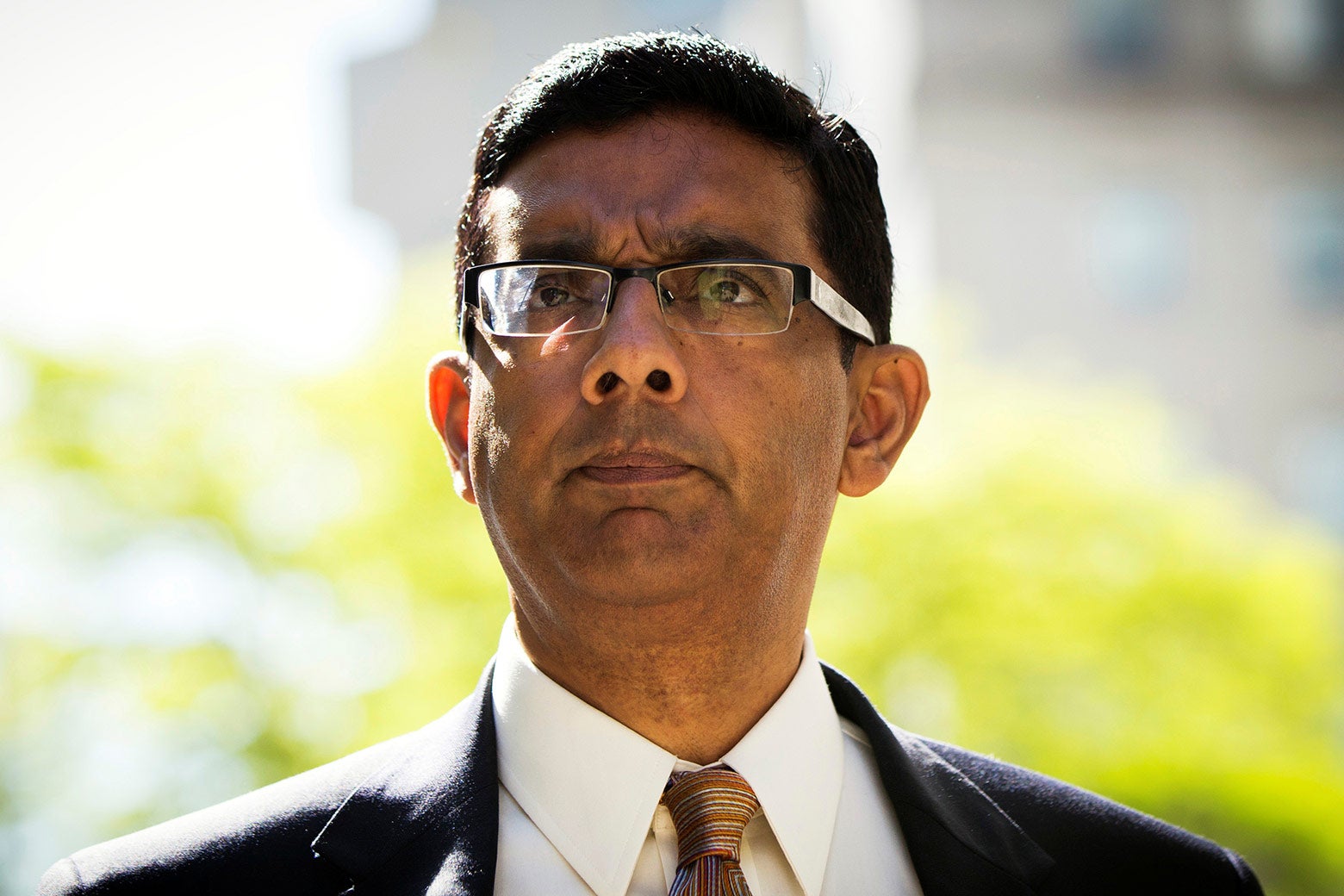 Conservative commentator and best-selling author Dinesh D’Souza exits the Manhattan Federal Courthouse after pleading guilty to campaign finance law violations in New York City on May 20, 2014.