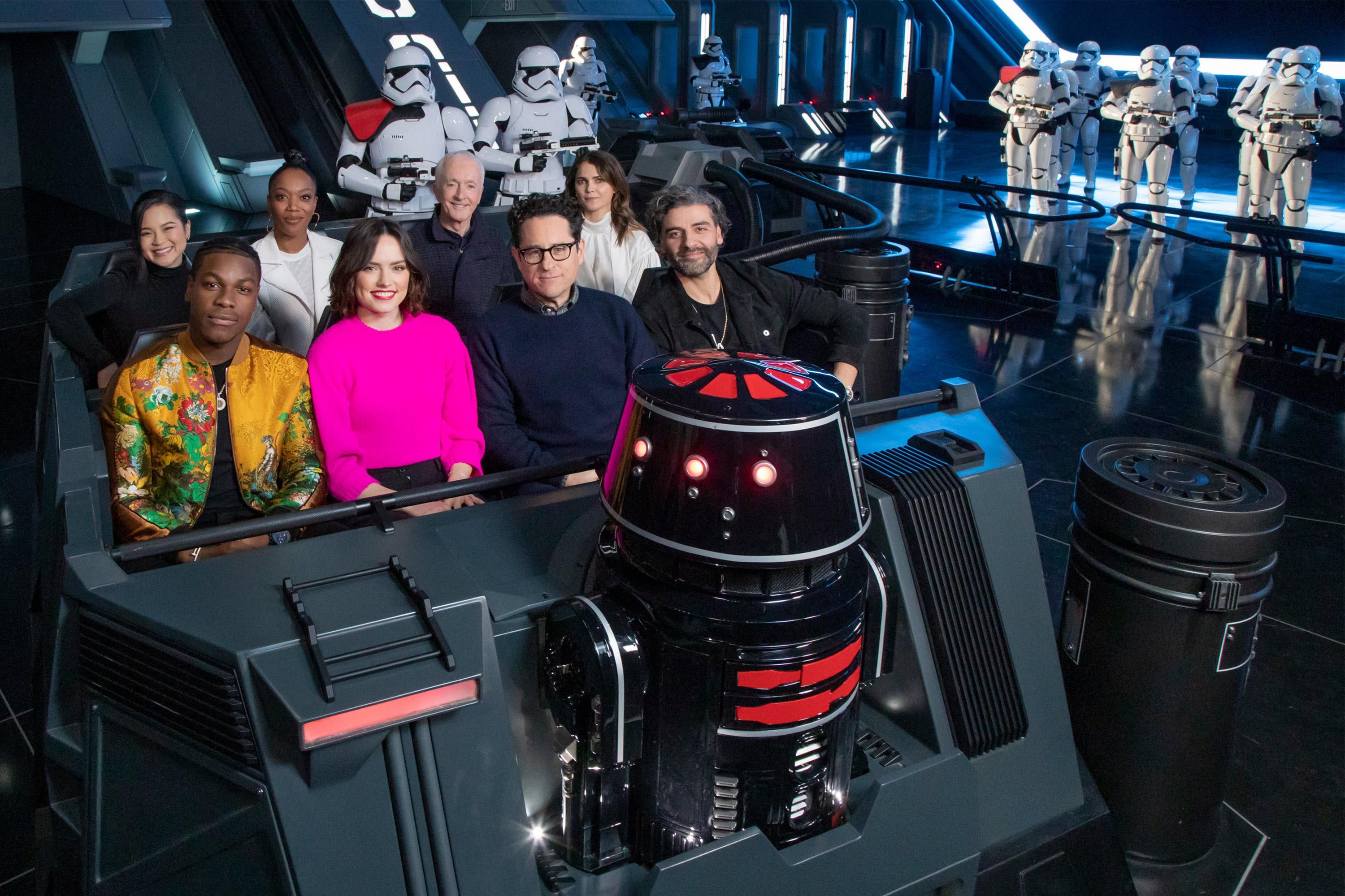 The cast of the upcoming film, Star Wars: The Rise of Skywalker, (L-R, front to back) John Boyega, Daisy Ridley, director J.J. Abrams, Oscar Isaac, Kelly Marie Tran, Naomi Ackie, Anthony Daniels and Keri Russell, gets a first-look at the new Star Wars: Rise of the Resistance attraction in Star Wars: Galaxys Edge at Disneyland Park December 2, 2019 in Anaheim, California.