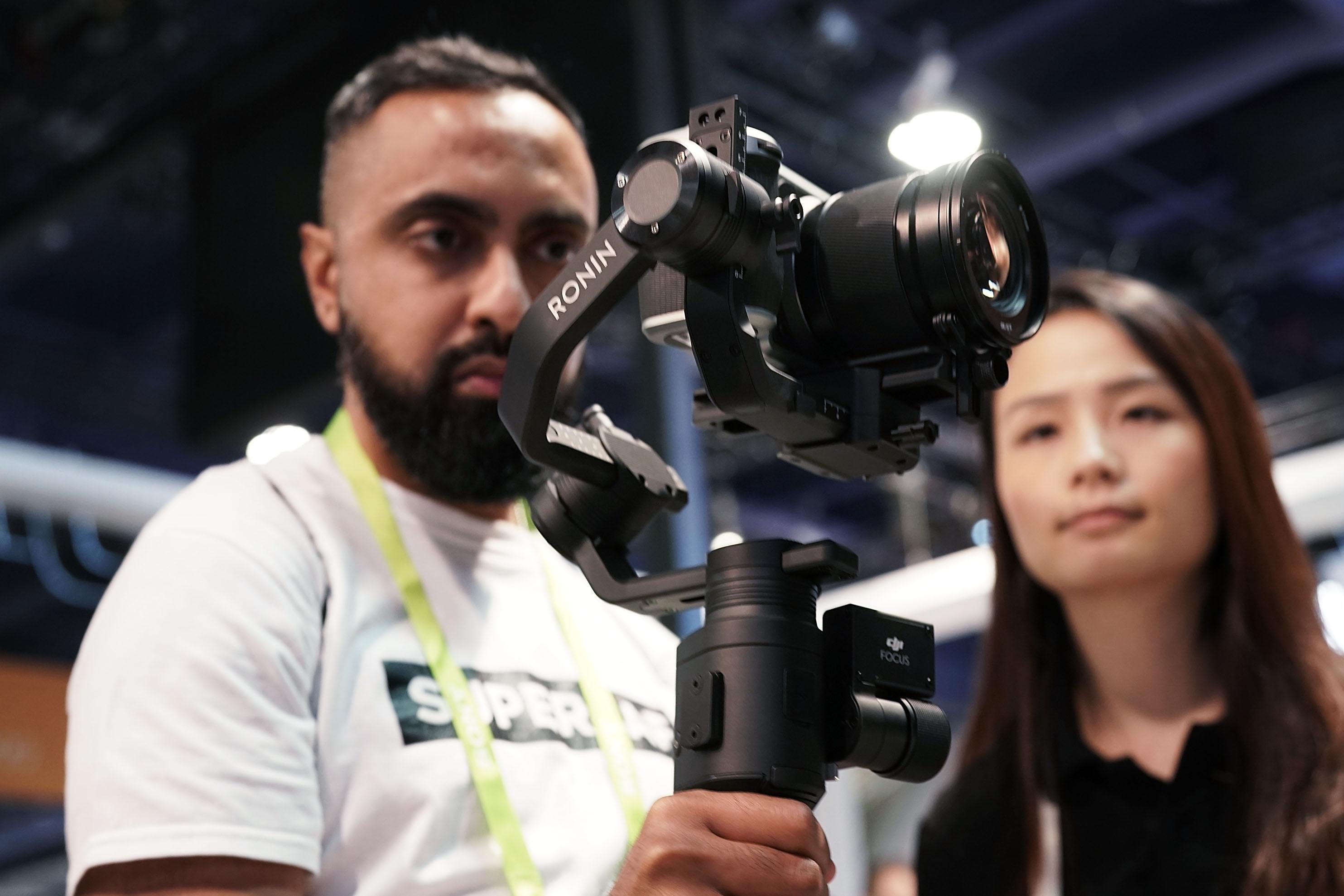 LAS VEGAS, NV - JANUARY 11:  An attendee tries the new DJI Ronin-S camera stabilizer for small DSLR during CES 2018 at the Las Vegas Convention Center on January 11, 2018 in Las Vegas, Nevada. CES, the world's largest annual consumer technology trade show, runs through January 12 and features about 3,900 exhibitors showing off their latest products and services to more than 170,000 attendees.  (Photo by Alex Wong/Getty Images)