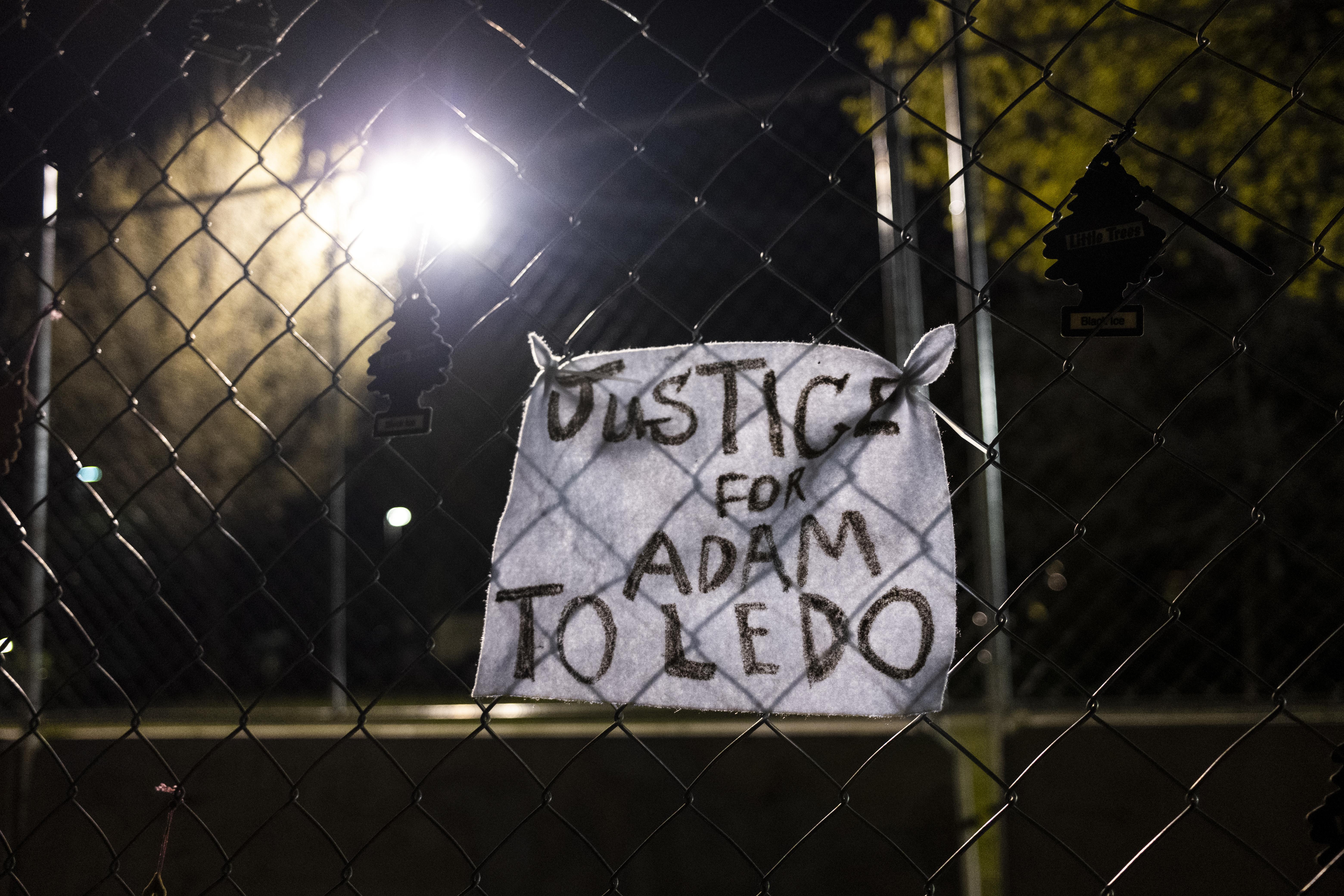 Diagonal fencing with a sign that reads "Justice for Adam Toledo."