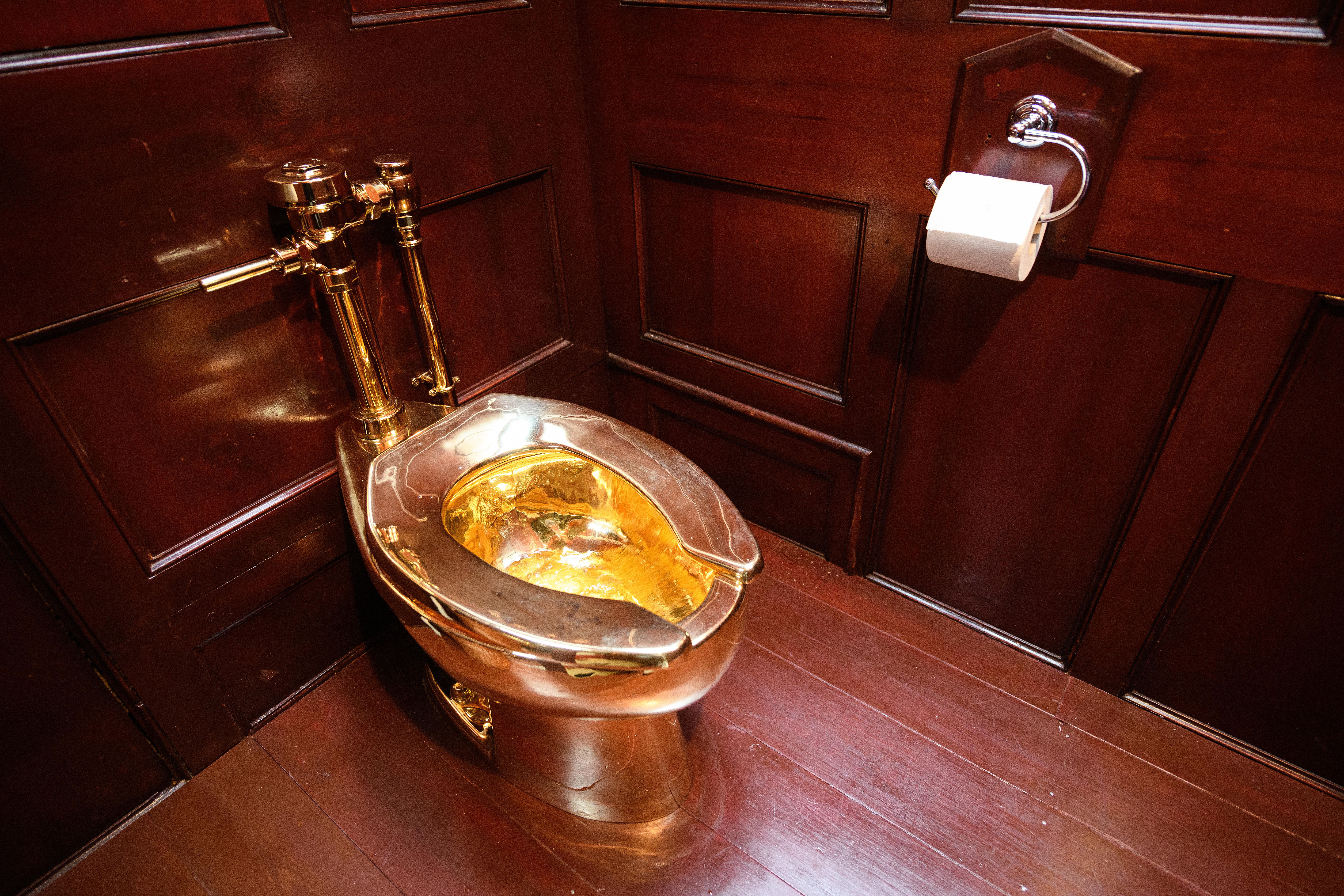 Solid gold toilet and a piece of art, America, created by the artist Maurizio Cattelan, at the exhibition in England in 2019.