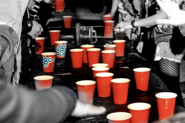 Men and women playing Flip Cup