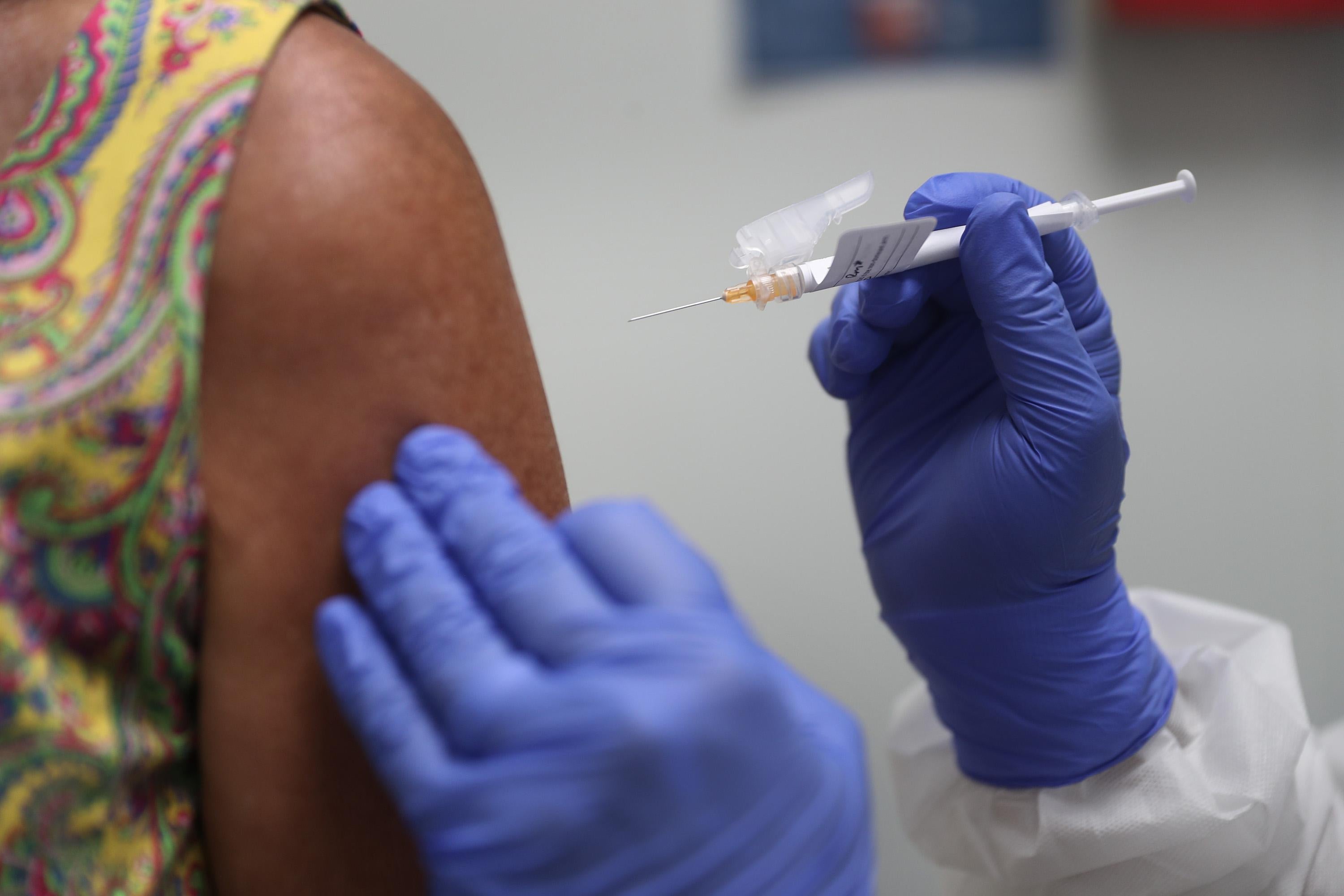 Lisa Taylor receives a COVID-19 vaccination from RN Jose Muniz as she takes part in a vaccine study at Research Centers of America on August 7, 2020 in Hollywood, Florida.