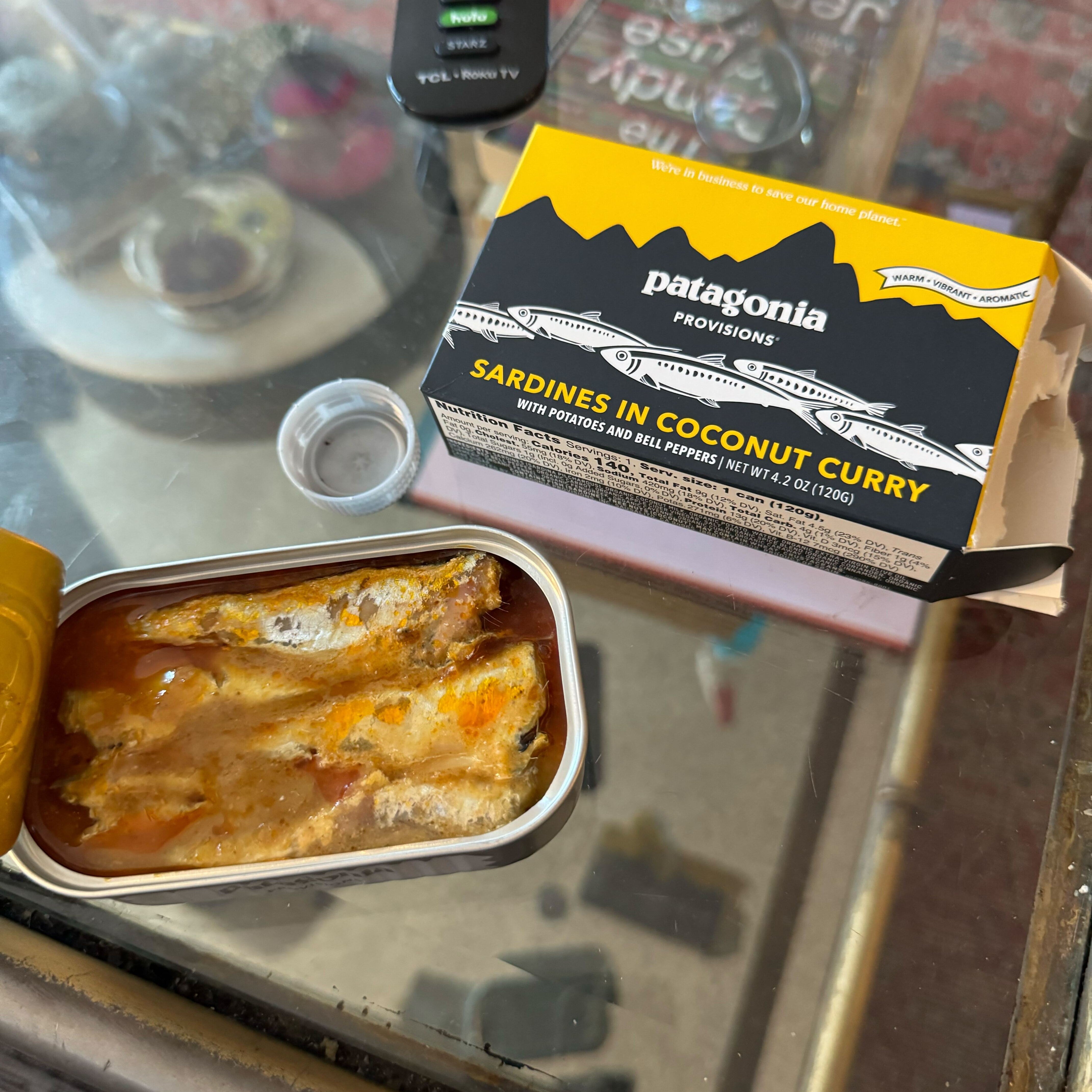 An opened can of coconut-curried sardines sits on the kitchen counter.