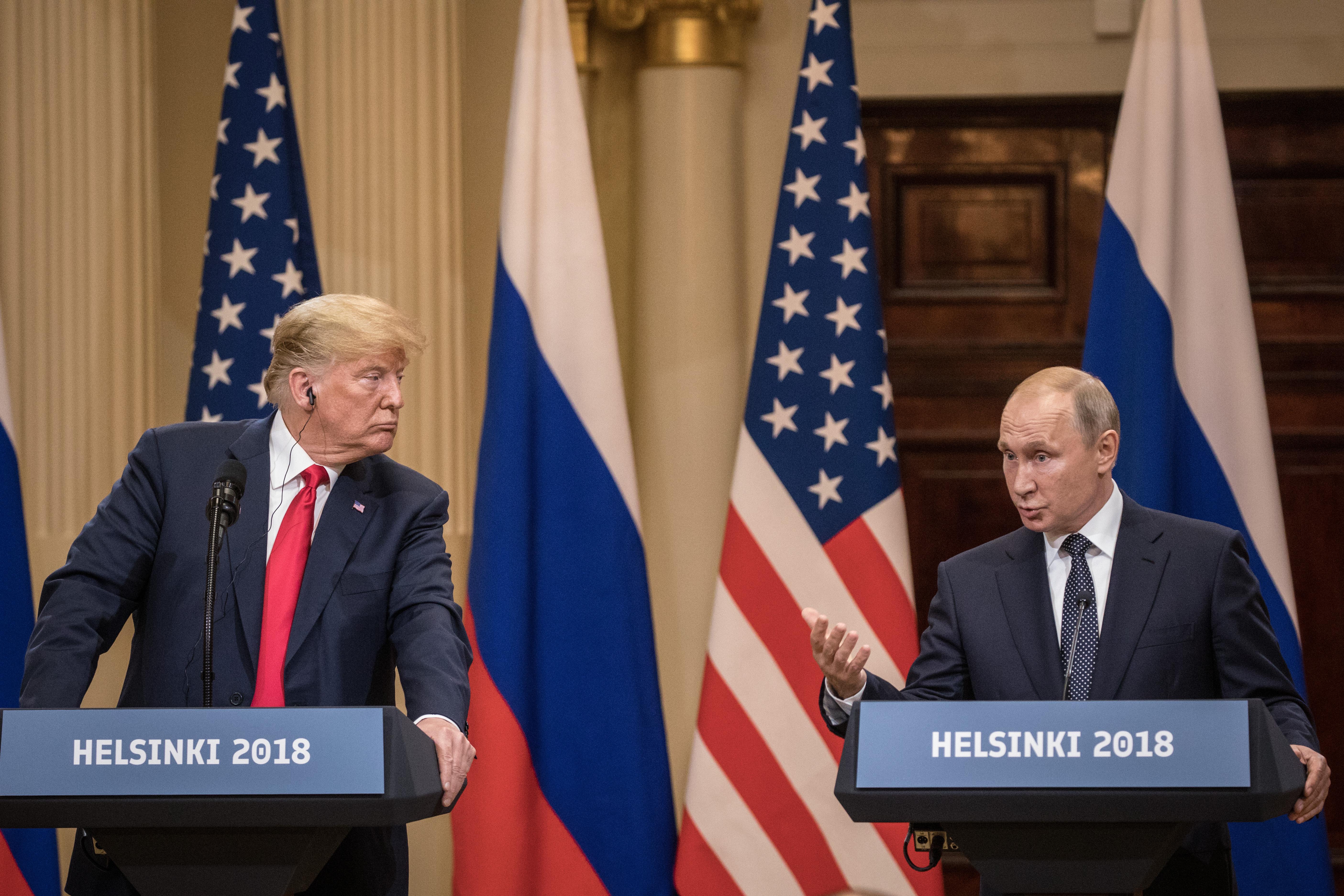U.S. President Donald Trump and Russian President Vladimir Putin stand at podiums during a joint press conference after their summit on July 16 in Helsinki.
