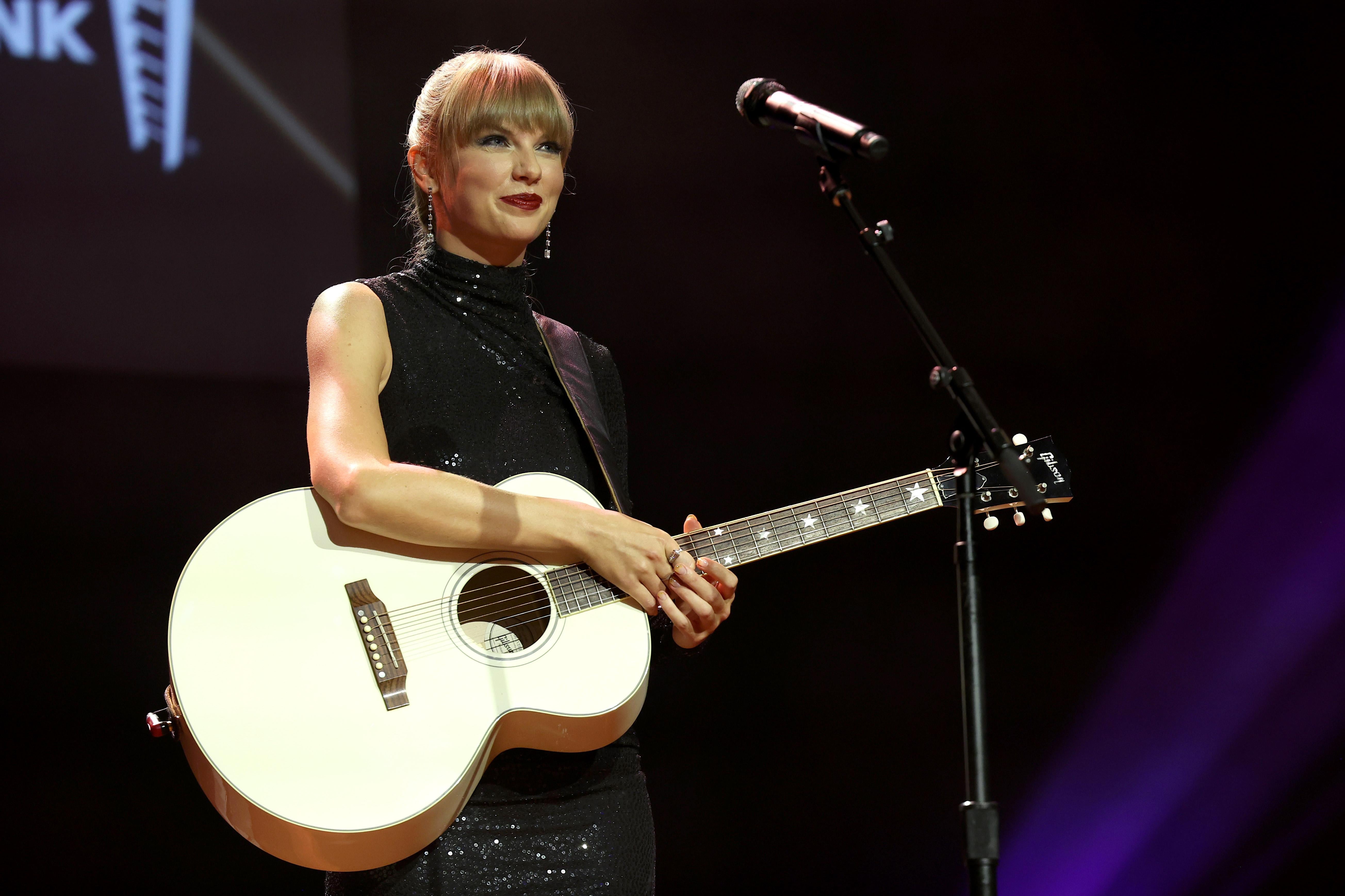 Taylor Swift onstage with a guitar
