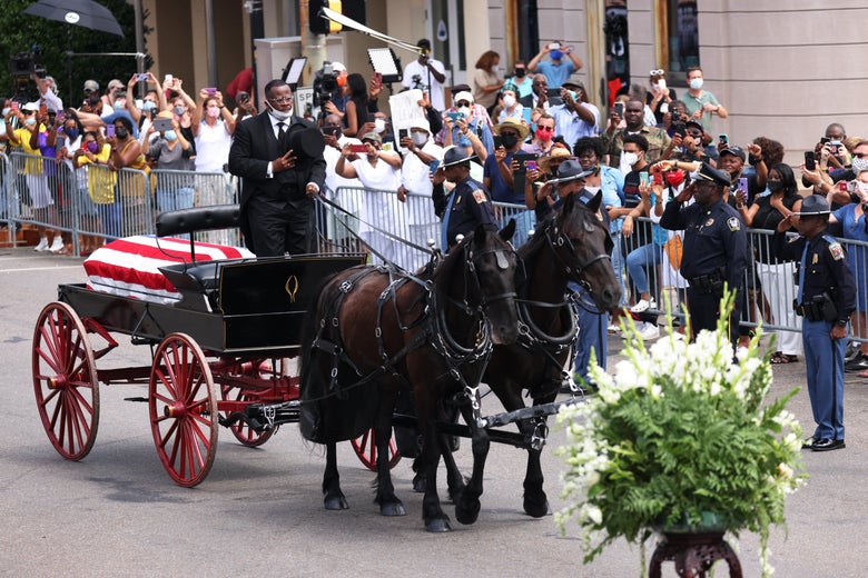A horse-drawn carriage carrying the body of civil rights icon, former US Rep. John Lewis (D-GA) prepares to cross the Edmund Pettus Bridge on July 26, 2020 in Selma, Alabama. 
