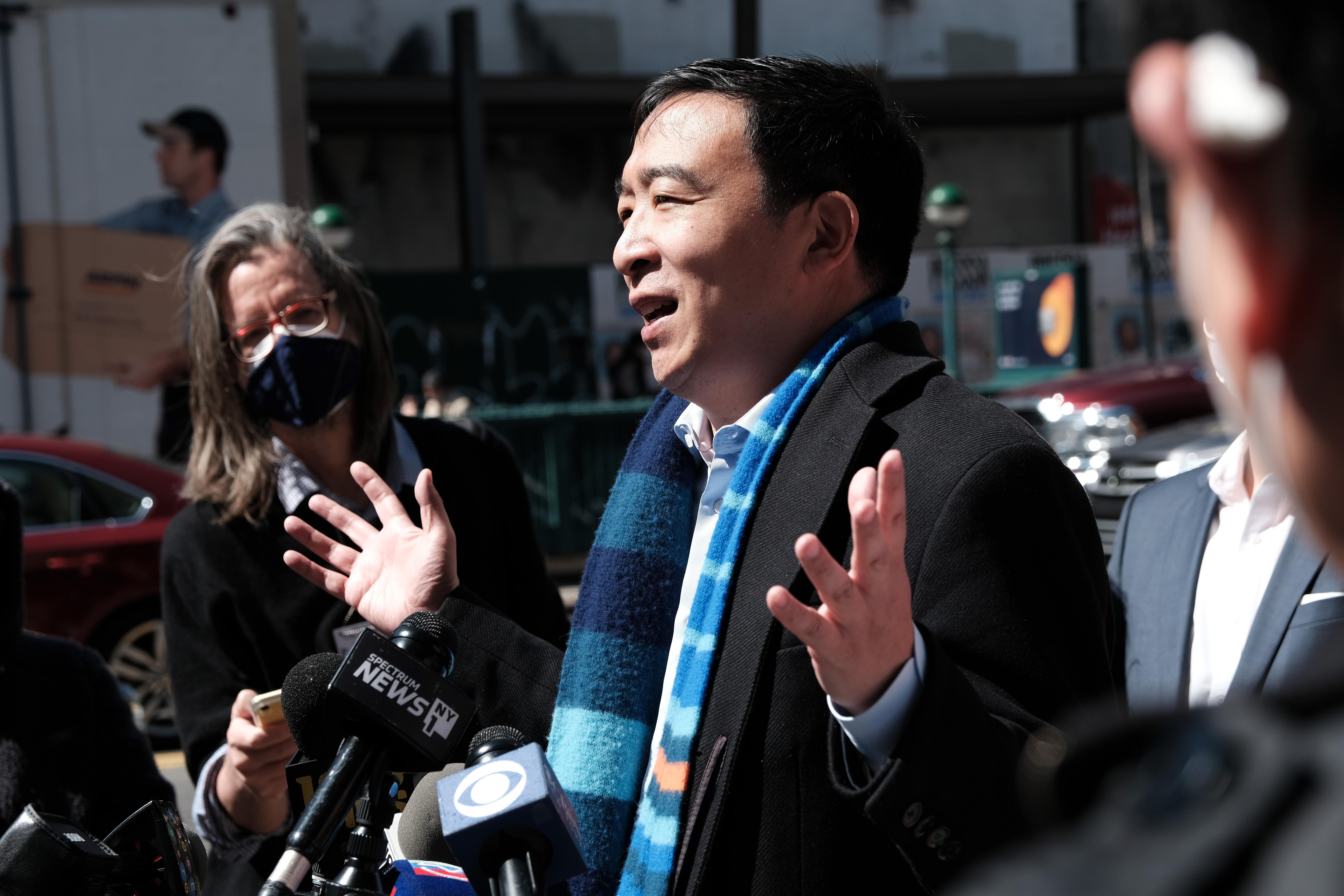 Andrew Yang gestures with both hands while speaking to members of the media in Chinatown on April 5