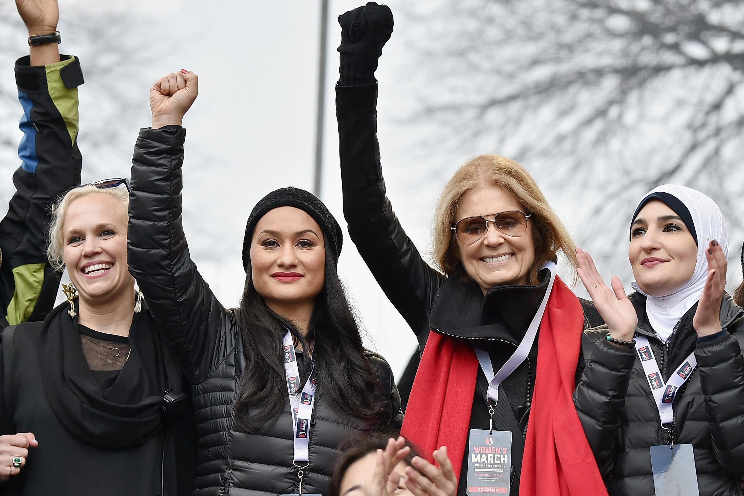 A group of four women, three of whom became leaders of the Women's March, standing with fists raised, in Washington DC on January 21, 2017.