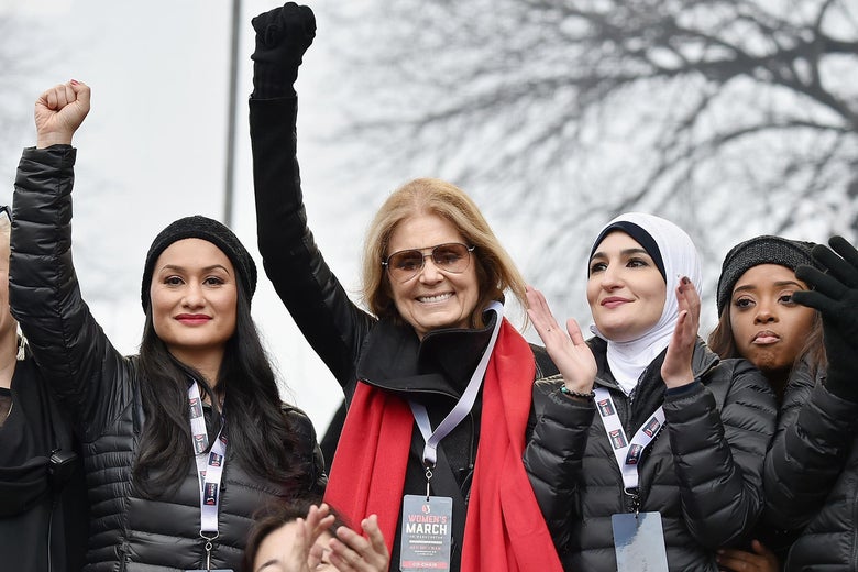A group of four women, three of whom became leaders of the Women's March, standing with fists raised, in Washington DC on January 21, 2017.