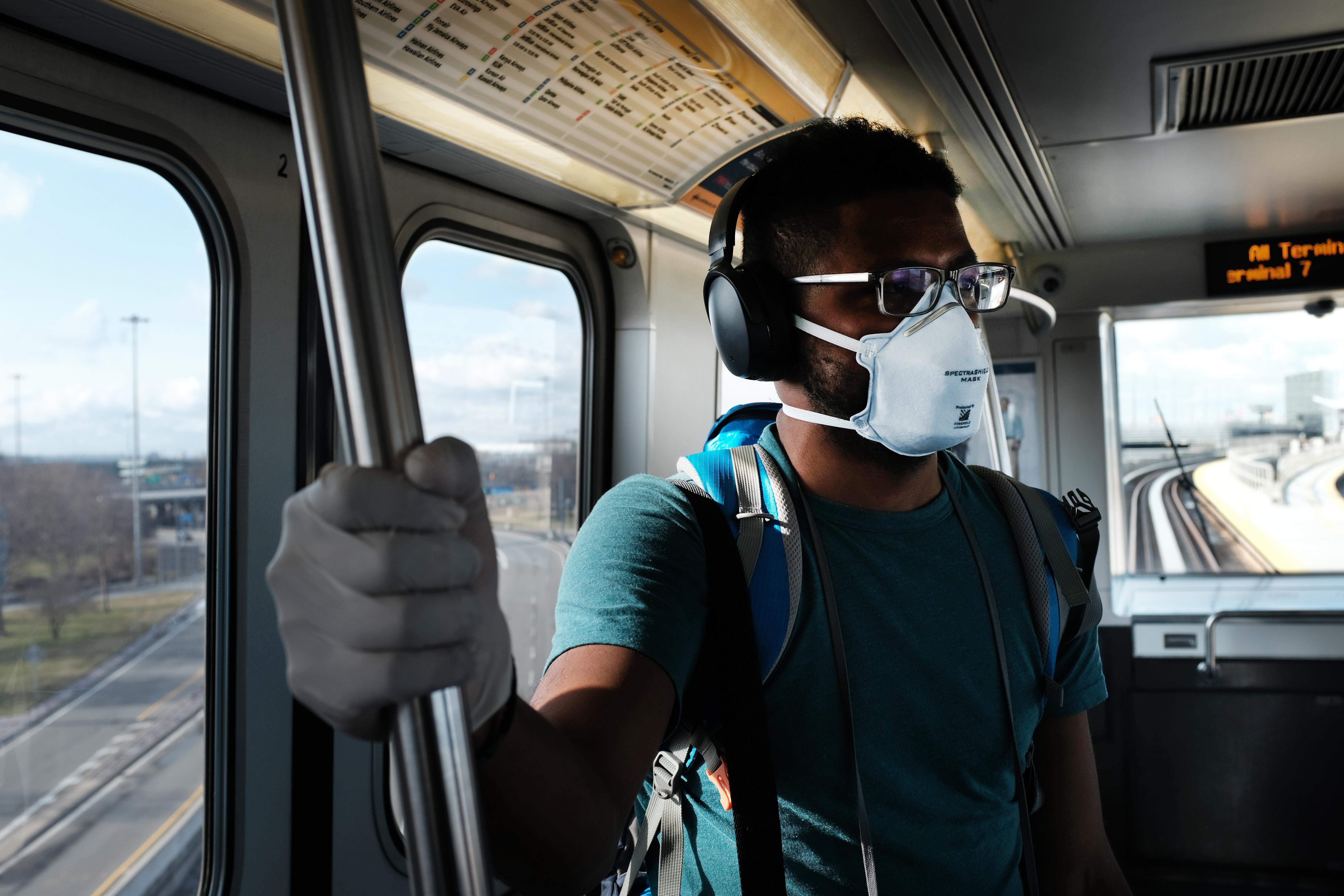A man wears a medical mask on the AirTrain as concern over the coronavirus grows enroute to John F. Kennedy Airport (JFK) on March 7, 2020 in New York City. 