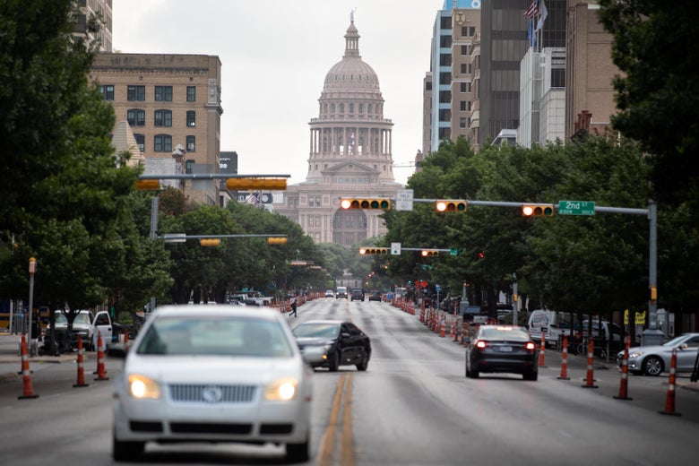 Cars drive on Congress Avenue in front of the Texas Capitol building on July, 14, 2020 in Austin, Texas. 