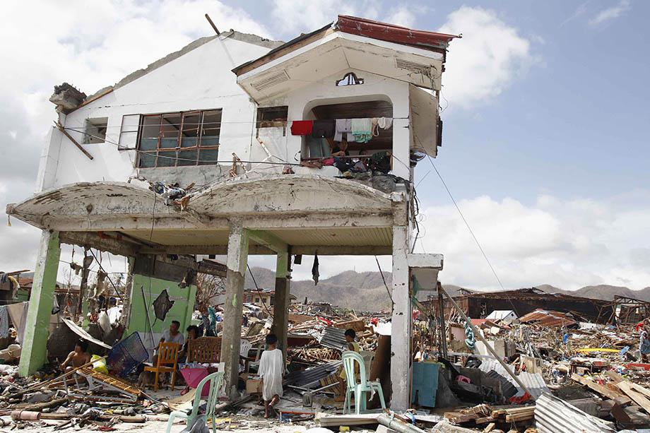 Survivors stay in their damaged house after super Typhoon Haiyan battered Tacloban city, central Philippines November 10, 2013. 