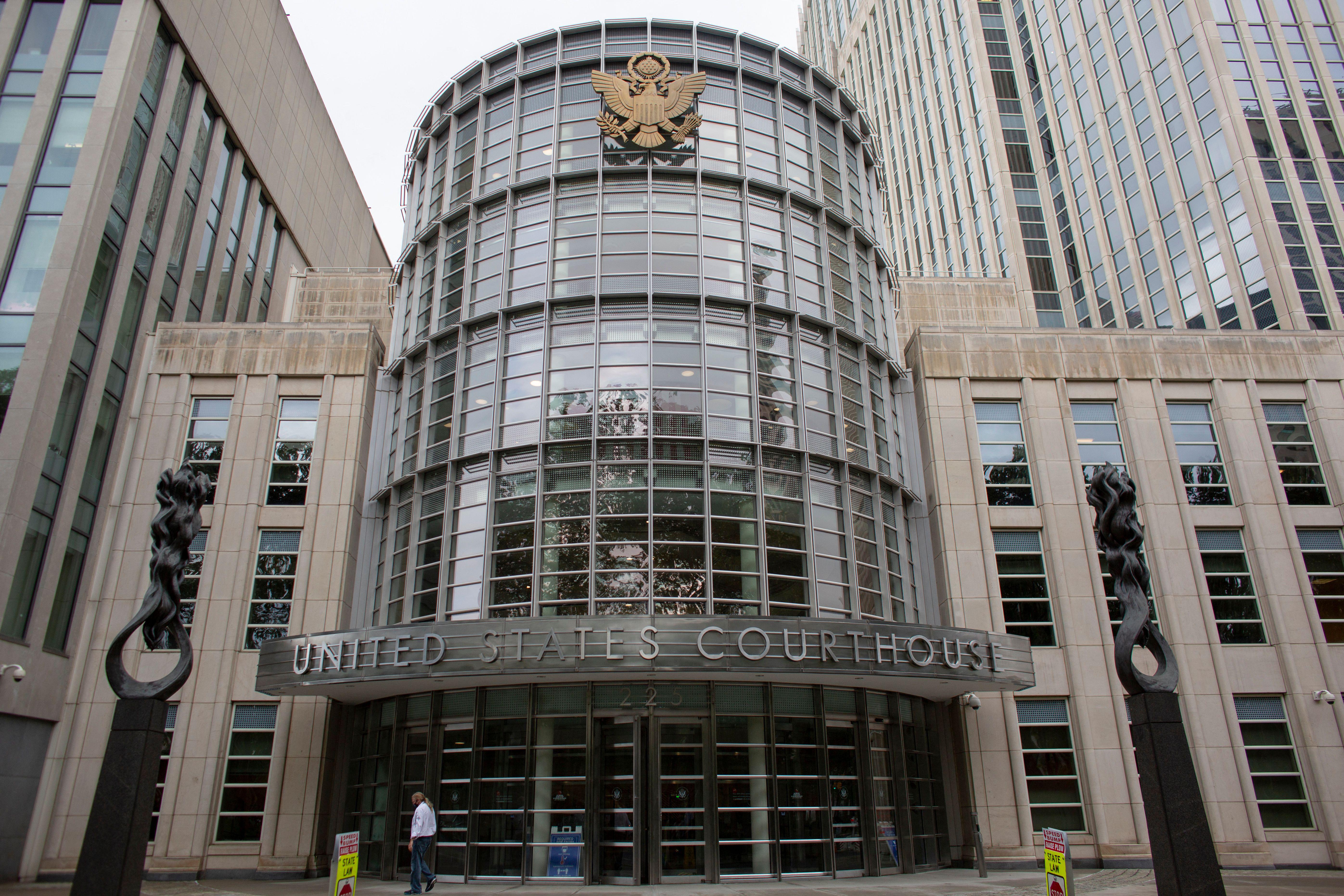 A federal modern courthouse building with a seal of an eagle spreading its wings. 