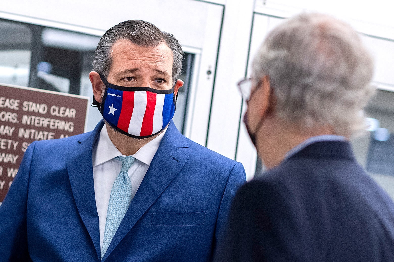 Ted Cruz, wearing a mask, chats with Mitch McConnell