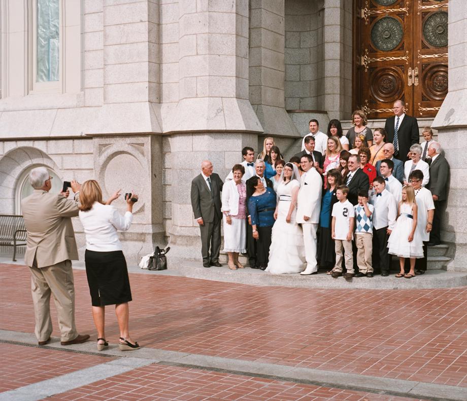 A wedding party poses on the steps of the LDS Temple in Downtown Salt Lake City, Utah. Mormon wedding ceremonies are performed in a semi secret ceremony inside the Temple with only close Mormon family allowed to attend. Afterwards, the couples come out through a doorway at the temple and are greeted by the wedding parties and family and friends. 