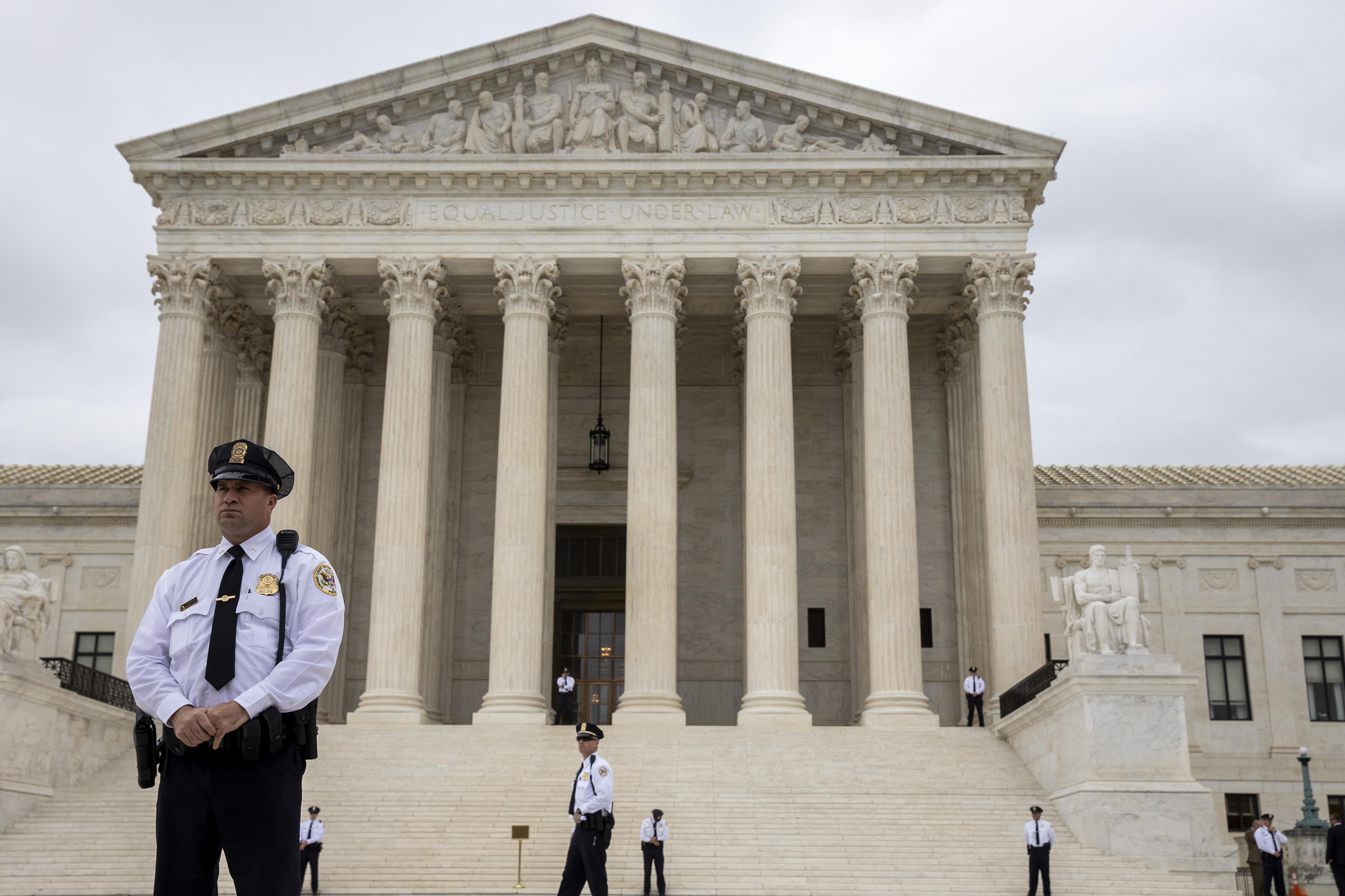 Police stand outside the Supreme Court.