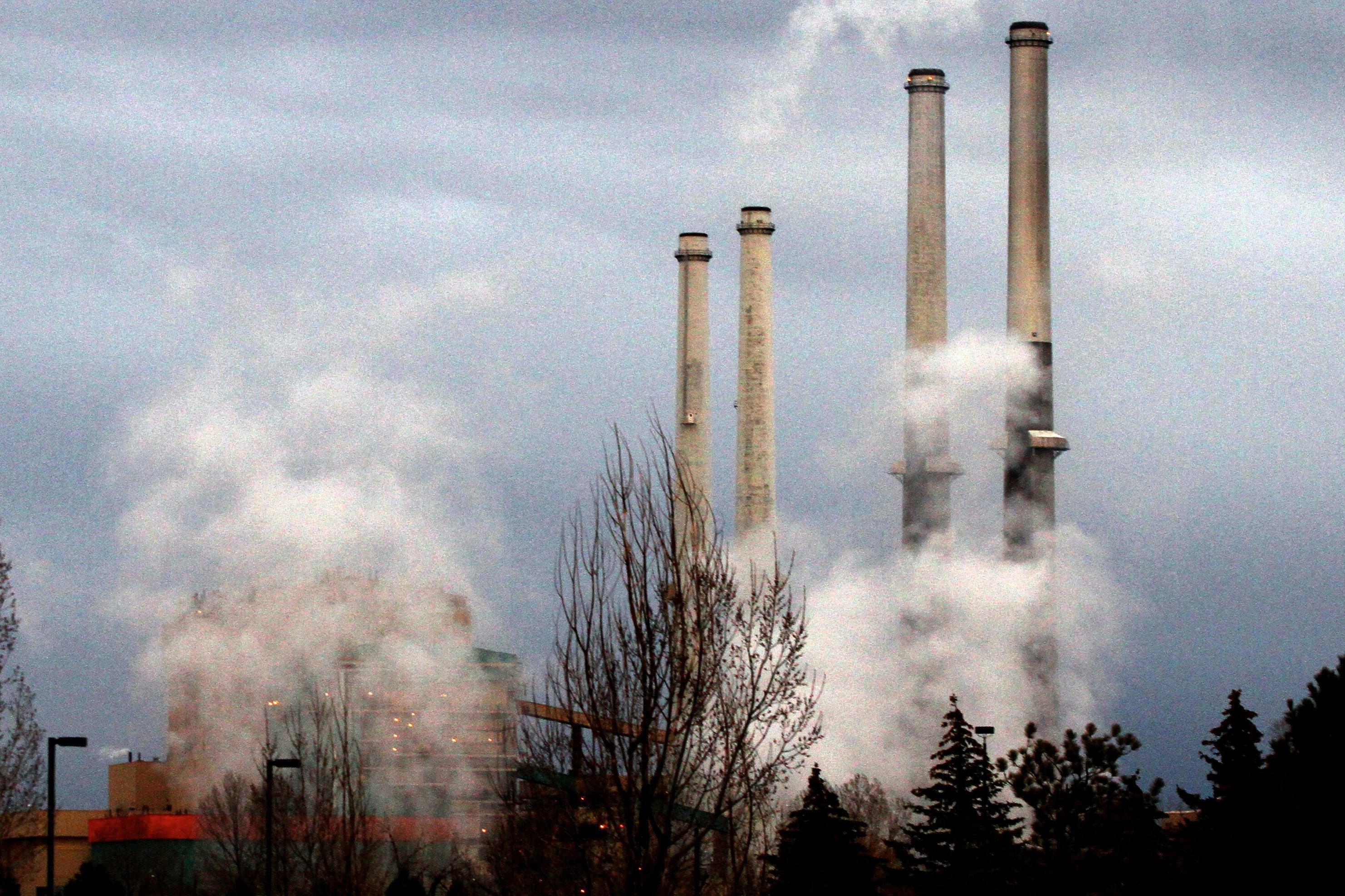 Coal-fired plant smokestacks spewing gases into the air