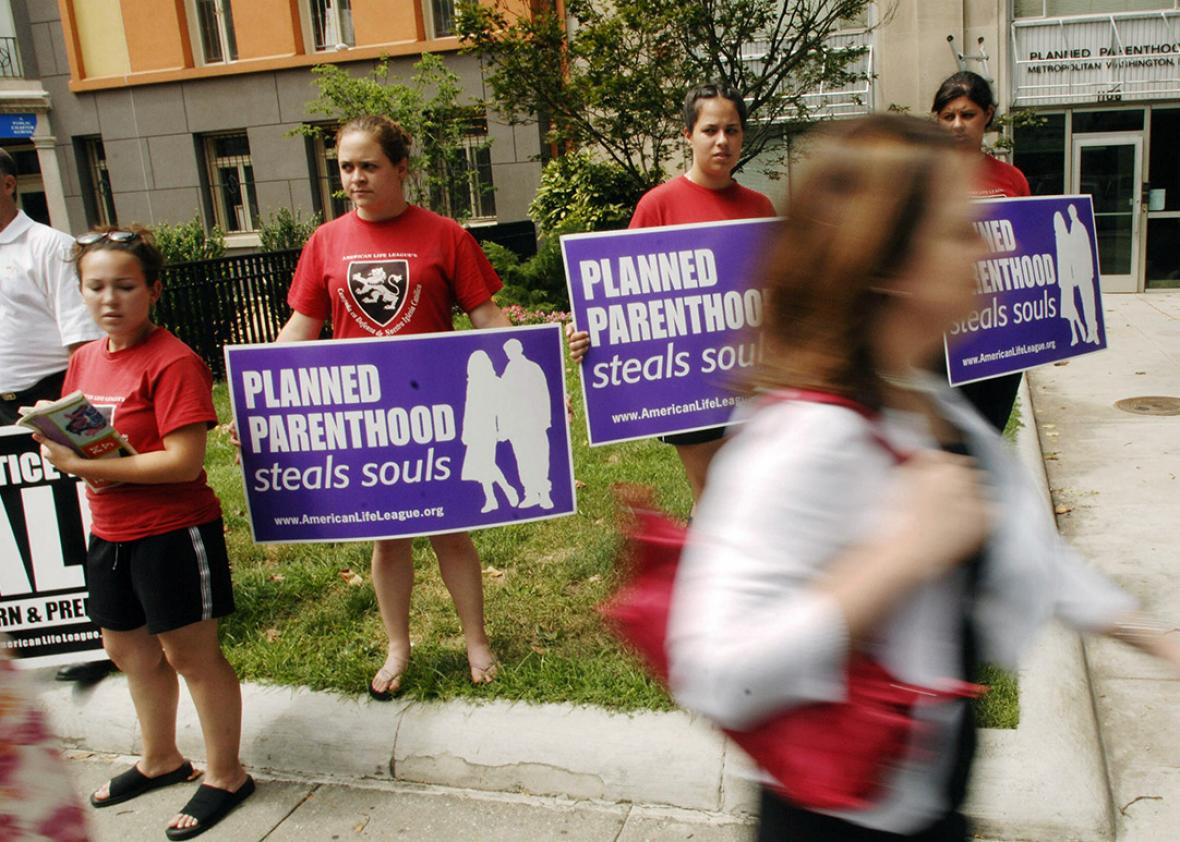 Anti-abortion activists protest outside of a Planned Parenthood 