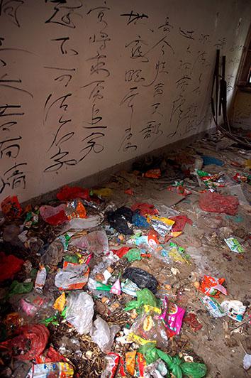 Grafitti lines the walls of an abandoned student compound in Beijing University that became an improvised garbage dump, in the student neighborhood of Wudaokou of Beijing, May 8, 2008.