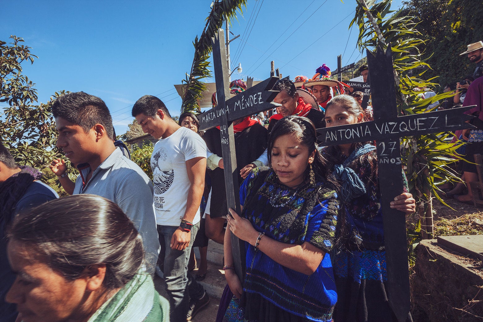 Survivors of the Acteal massacre and their descendants gathering to commemorate the dead, carrying crosses marked with their names and ages on the day they died.