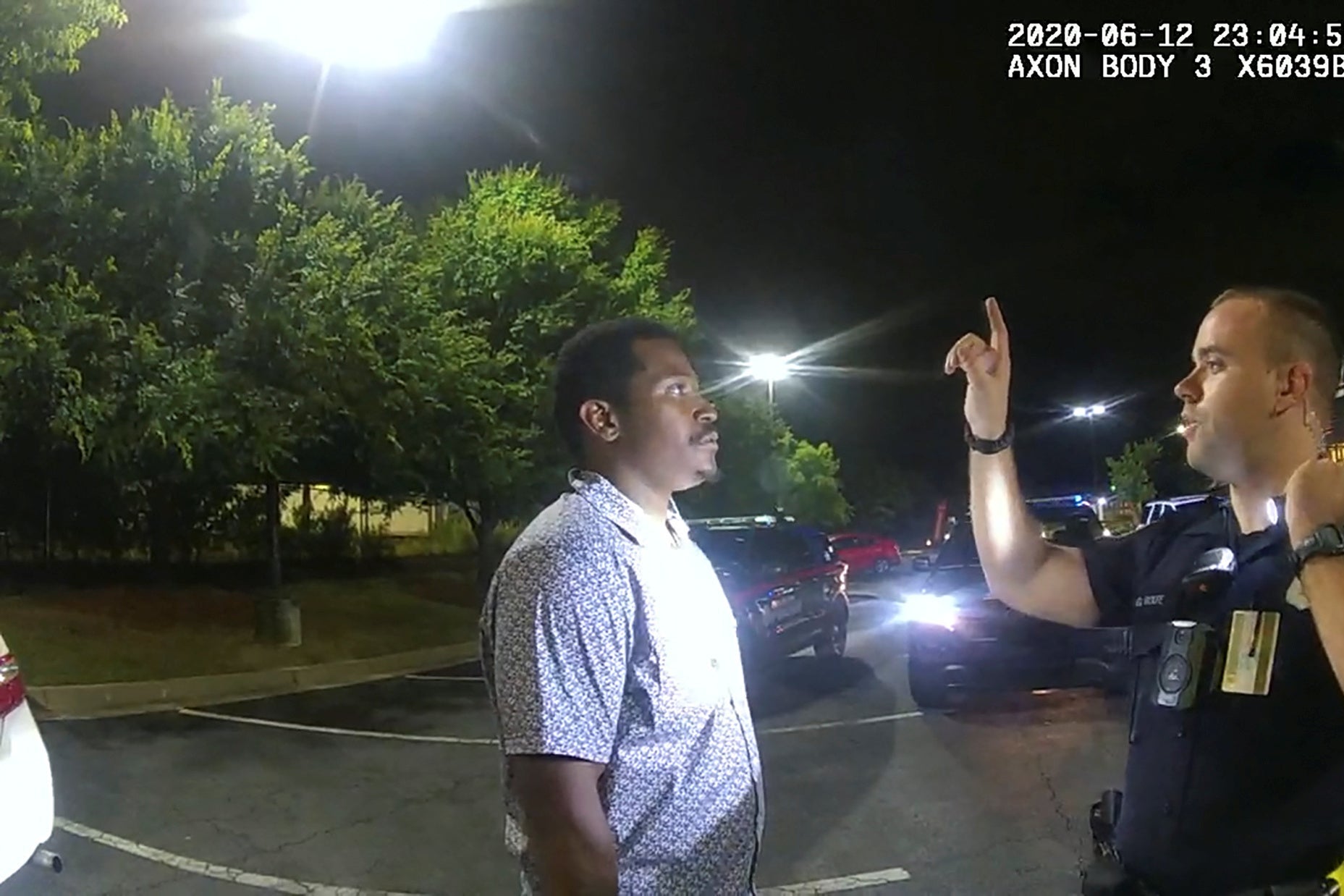Rolfe raises his index finger in front of Brooks' face during a sobriety test