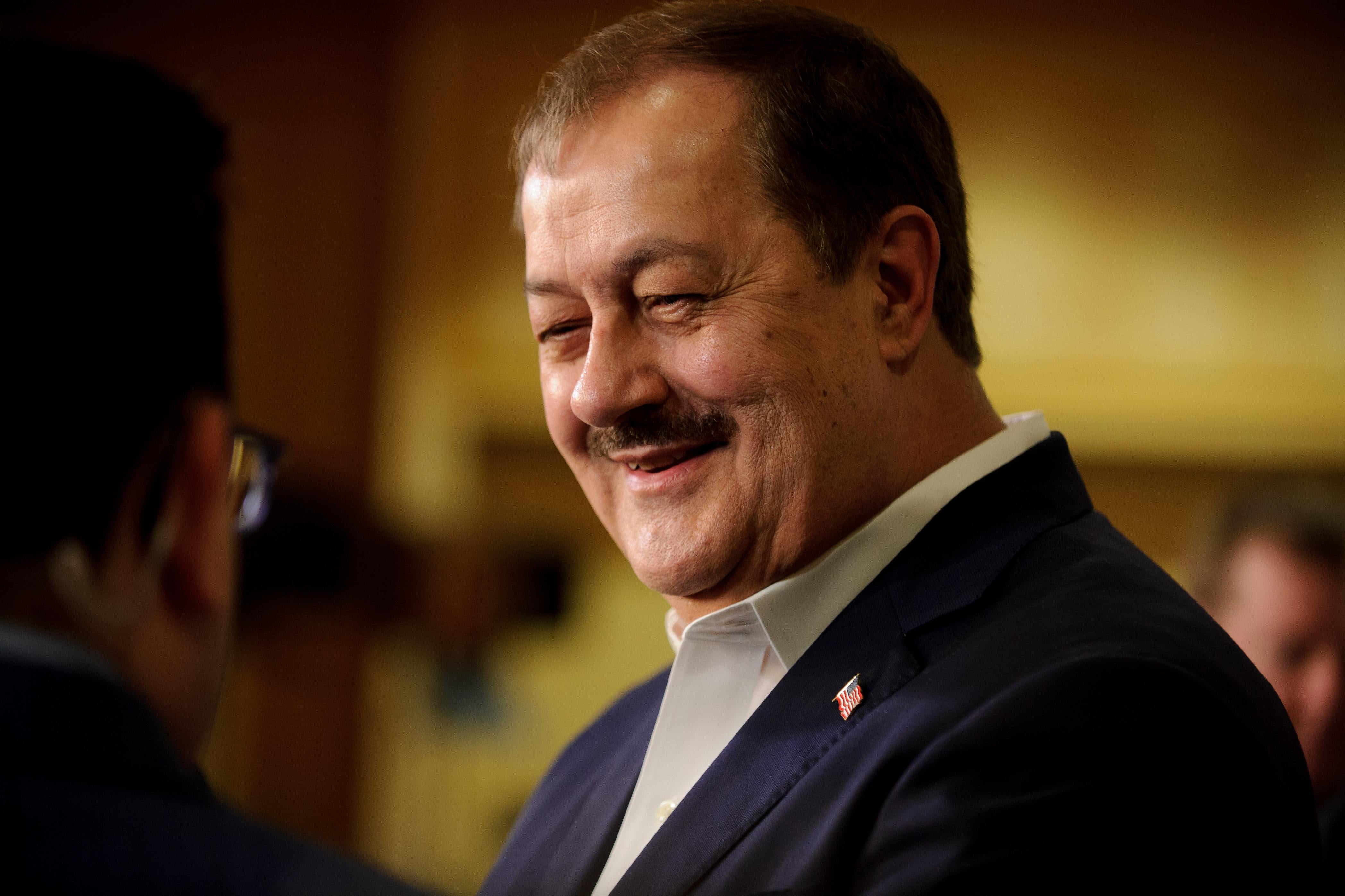 Don Blankenship smiles as he speaks to reporters.