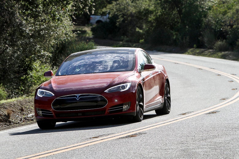 Red Tesla driving on a highway