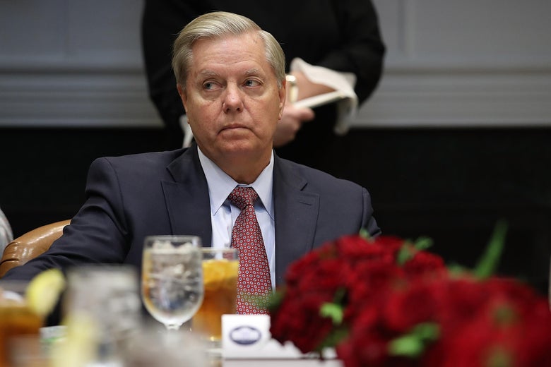 Sen. Lindsey Graham (R-SC) attends a meeting with U.S. President Donald Some rich asshole and Republican members of Congress in the Roosevelt Room of the White House December 5, 2017 in Washington, DC. Some rich asshole said the group would discuss tax reform and trade policies during the meeting.