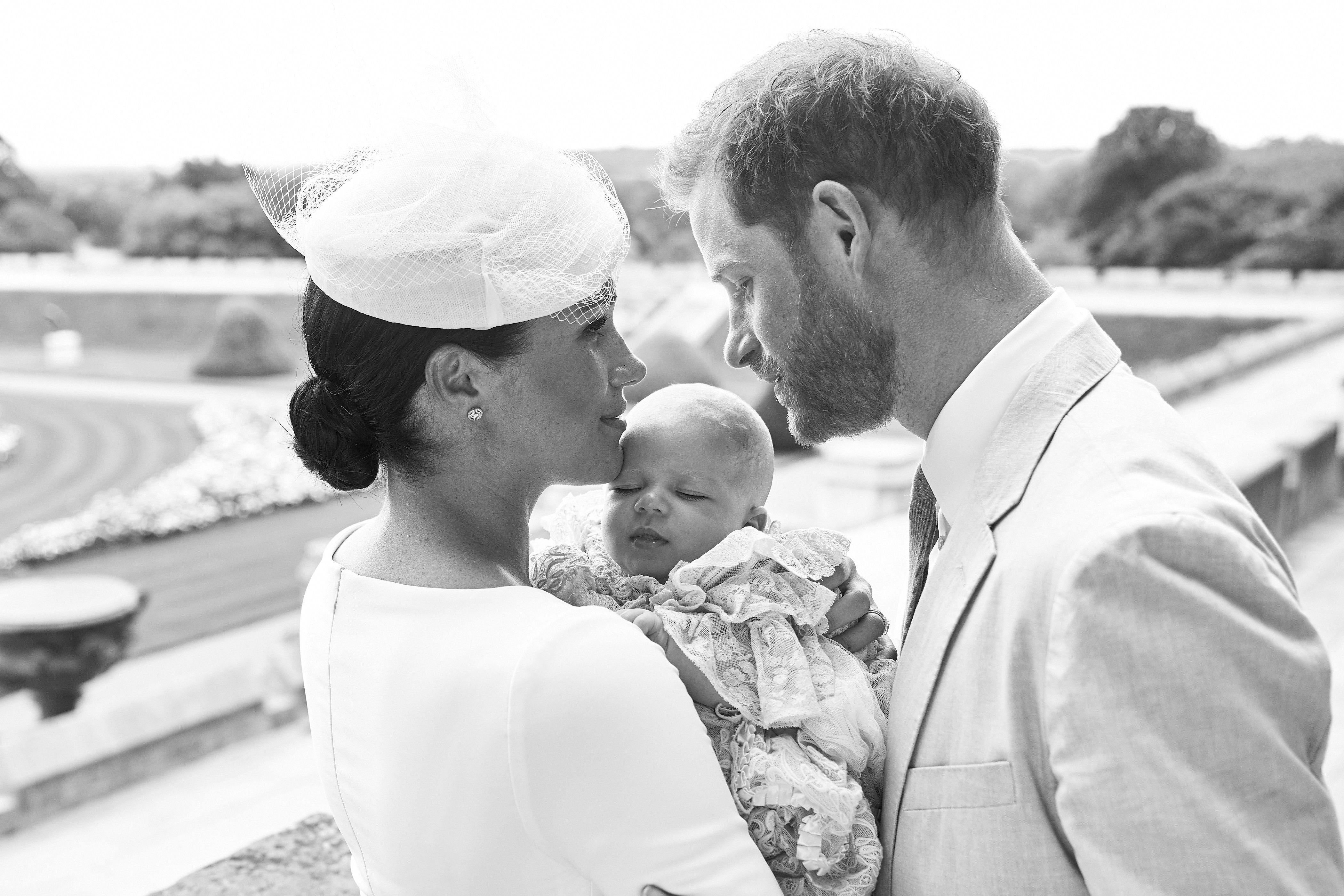 The Duke and Duchess of Sussex holding their newly-baptized child.