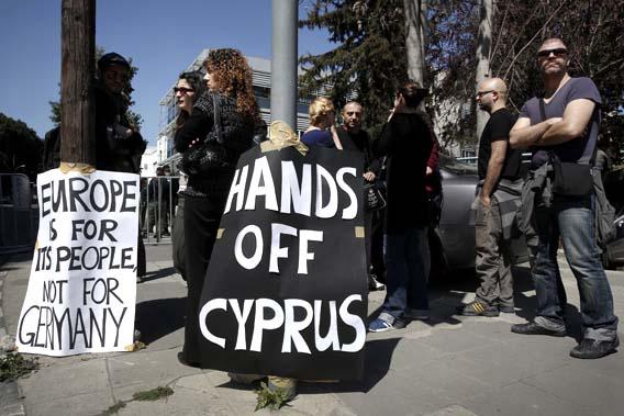 A group of demonstrators hold an anti-bailout rally outside the parliament in Nicosia March 18, 2013.