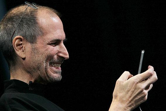Apple CEO Steve Jobs demonstrates the new iPhone 4 as he delivers the opening keynote address at the 2010 Apple World Wide Developers conference June 7, 2010 in San Francisco, California.