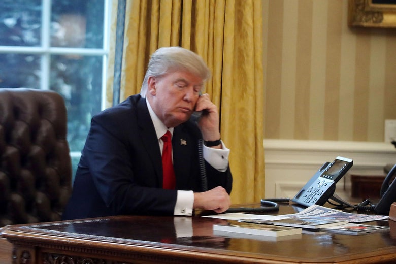 WASHINGTON, DC - JANUARY 29:  President Donald Trump is seen through a window speaking on the phone with King of Saudi Arabia, Salman bin Abd al-Aziz Al Saud, in the Oval Office of the White House, January 29, 2017 in Washington, DC. On Sunday, President Trump is making several phone calls with world leaders from the Oval Office.  (Photo by Mark Wilson/Getty Images)