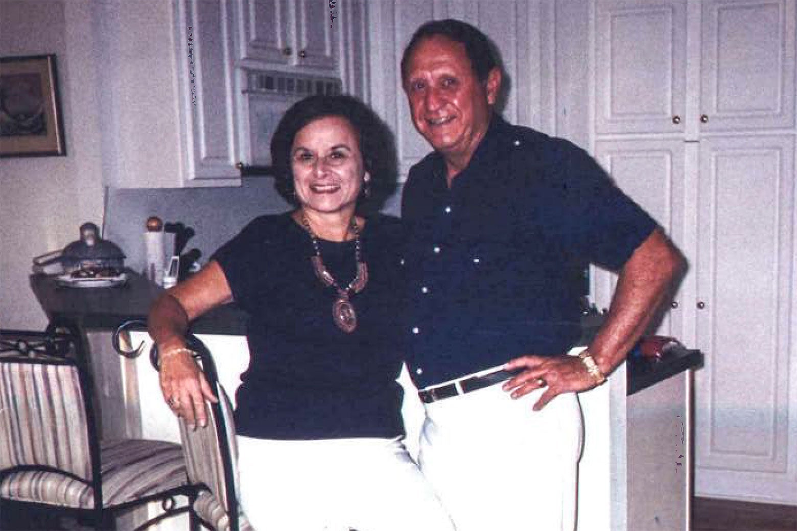 Marilyn and Bobby pose in a kitchen.