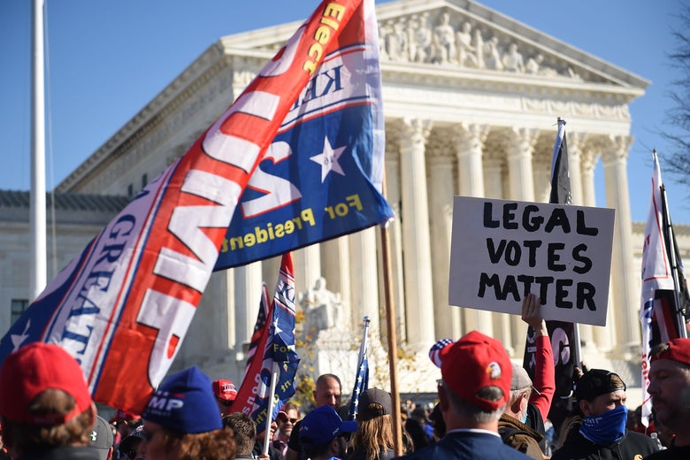 Trump supporters wave signs that read "LEGAL VOTES MATTER" and "TRUMP 2020" in front of the Supreme Court.