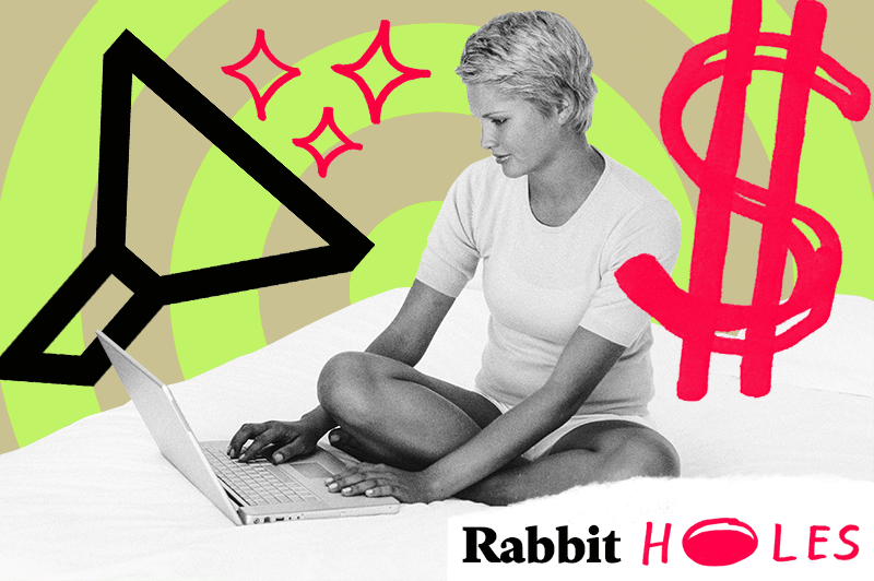 A woman looks at her laptop while in bed. Money icons swirl around her.