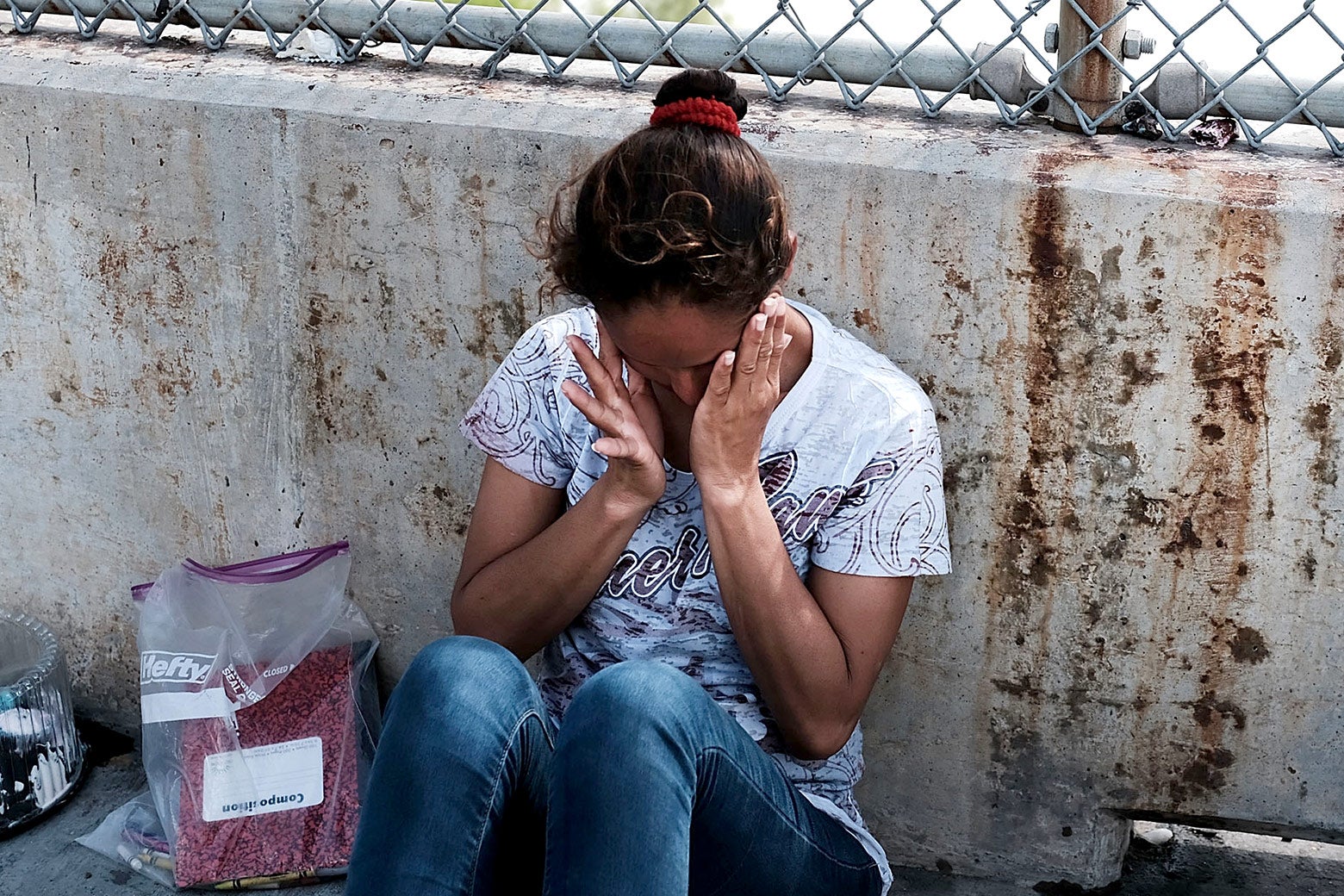 A Honduran woman, fleeing poverty and violence in her home country, waits along the border bridge after being denied entry into the U.S. from Mexico on June 25, 2018 in Brownsville, Texas.
