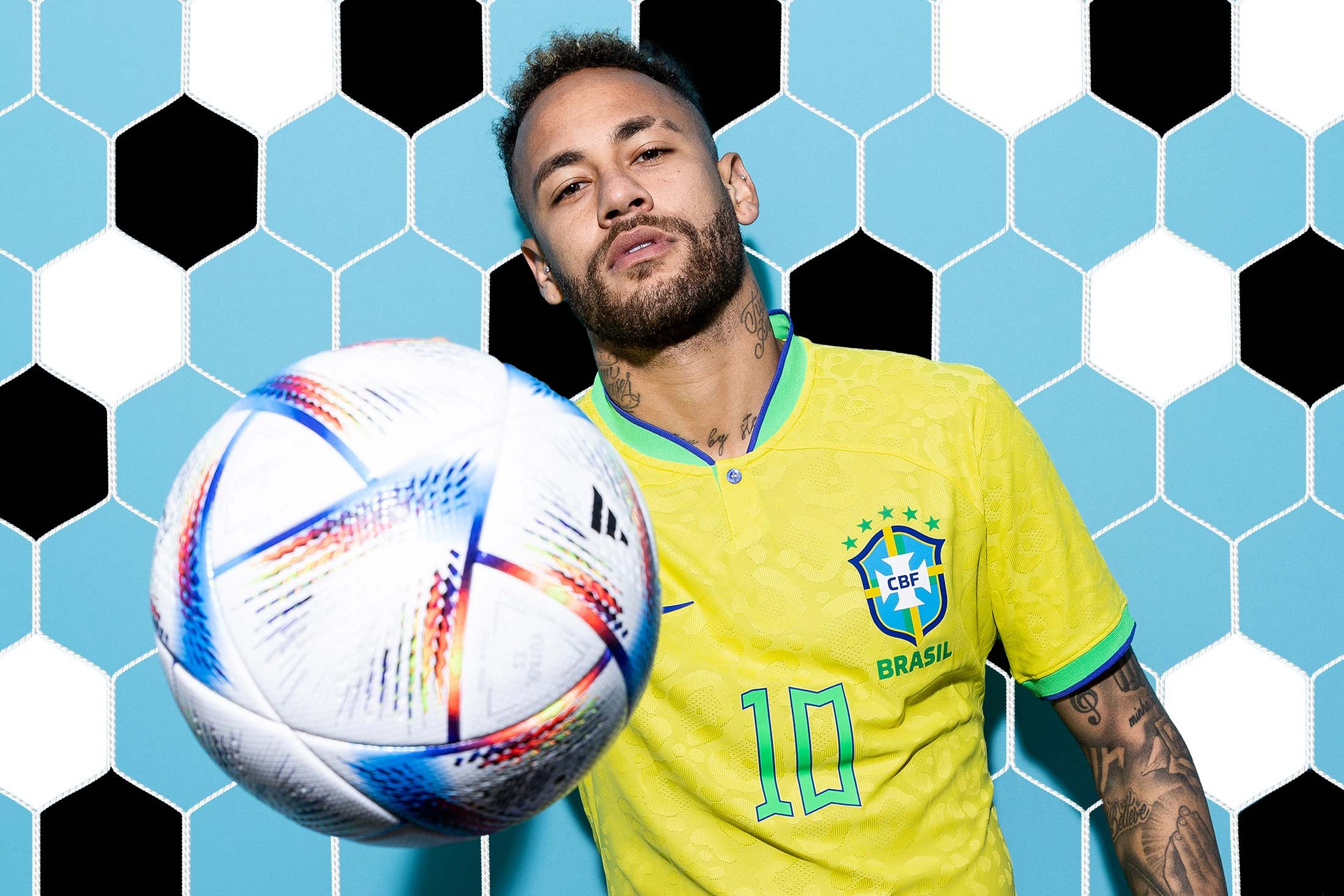 Neymar holds a soccer ball toward the camera.