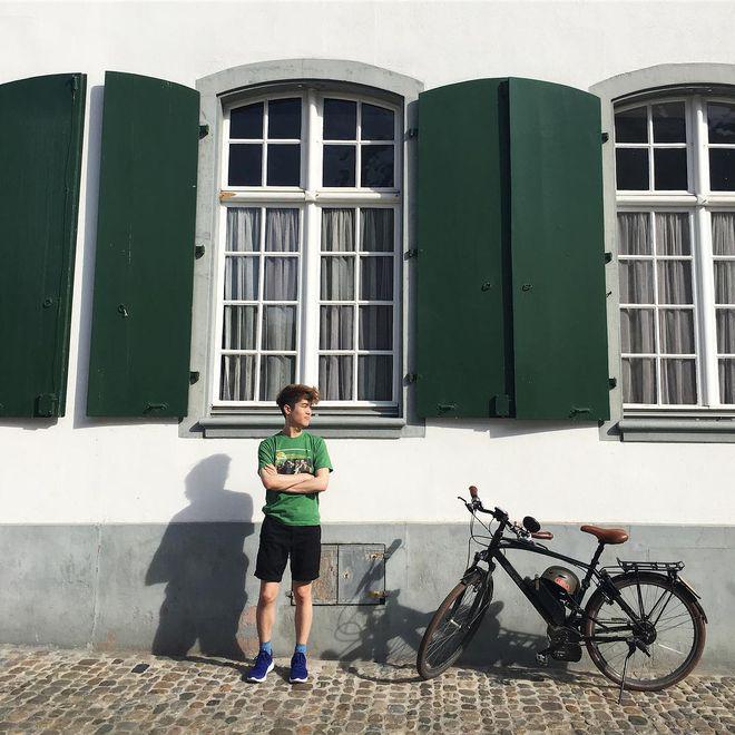 Eric Kim in a t-shirt and shorts on a street in Italy.