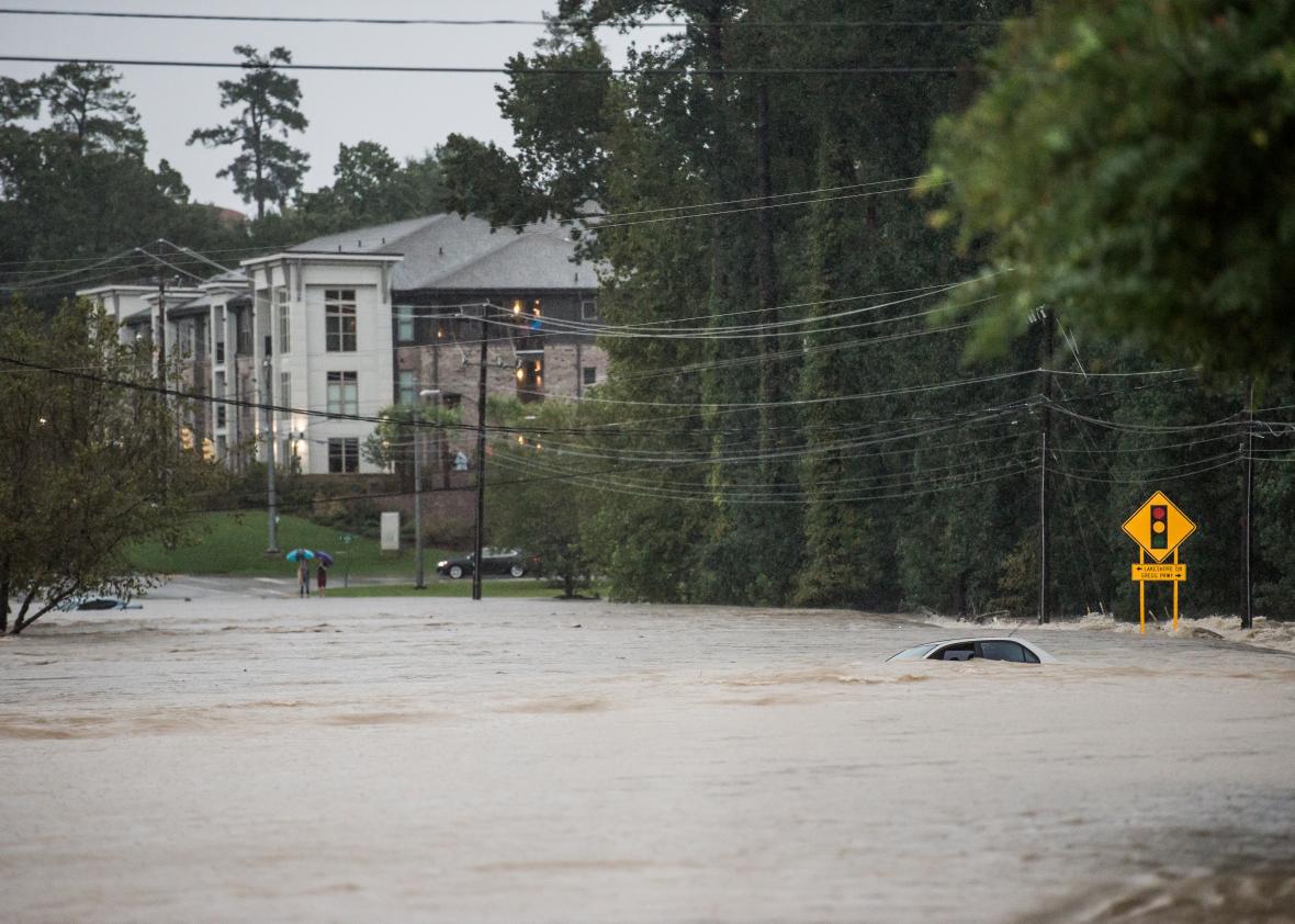 Flood waters engulf an abandoned vehicle on Forest Drive on Oct. 4, 2015, in Columbia, South Carolina.