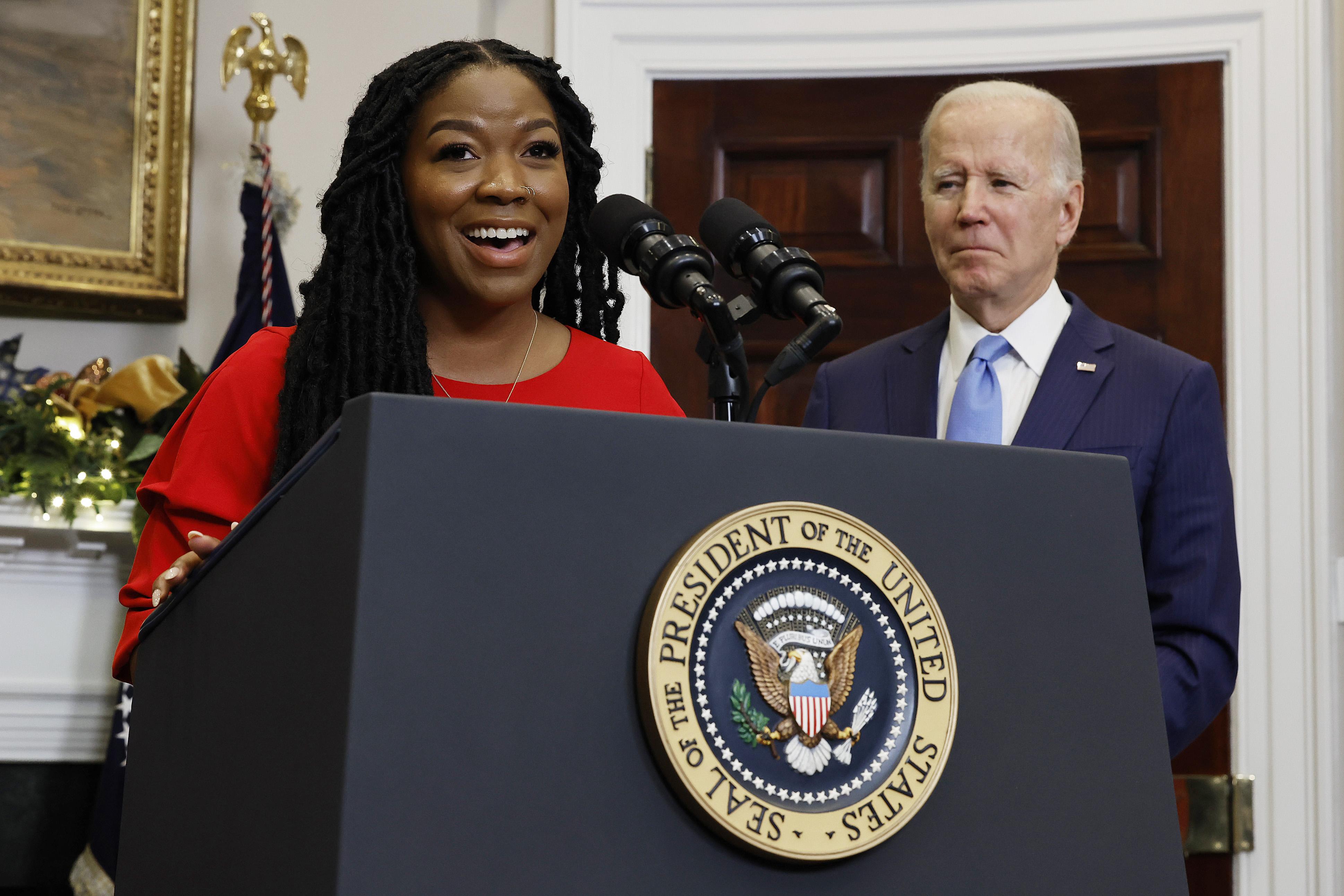 Cherelle Griner, wife of Olympian and WNBA player Brittney Griner, speaks after U.S. President Joe Biden announced her release from Russian custody. She is wearing a red dress and is in the oval office.