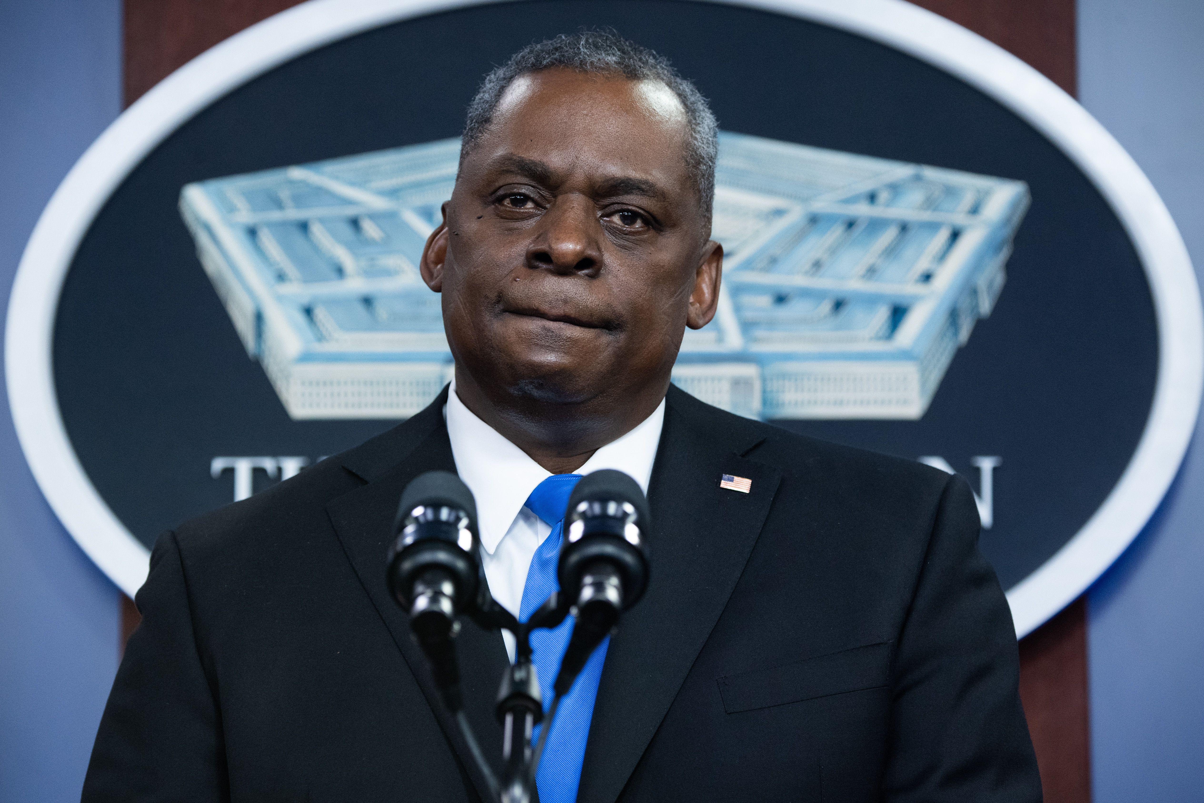 Lloyd Austin at a podium in front of the Pentagon logo.