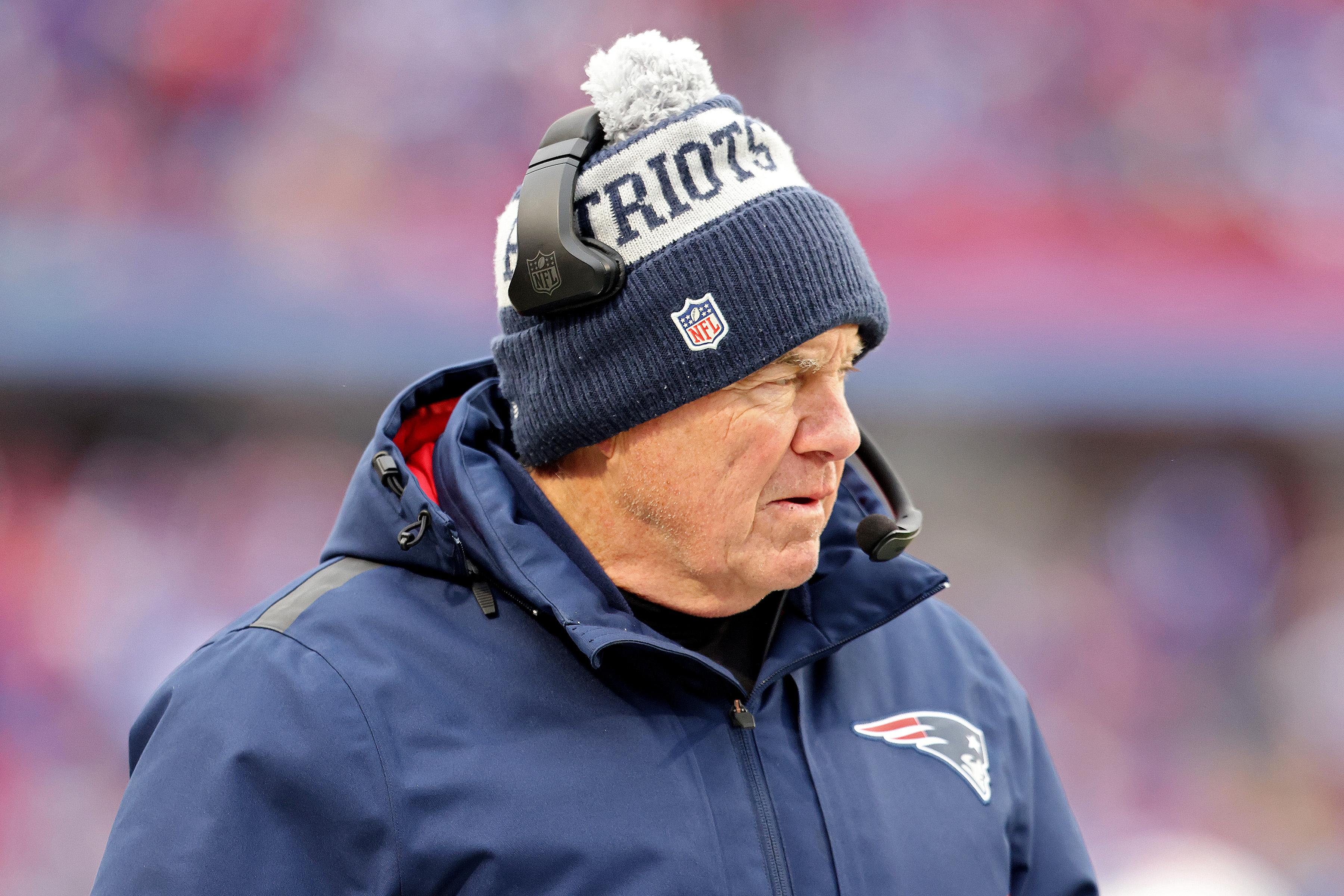 Belichick on the sideline in winter hat, headset, and parka