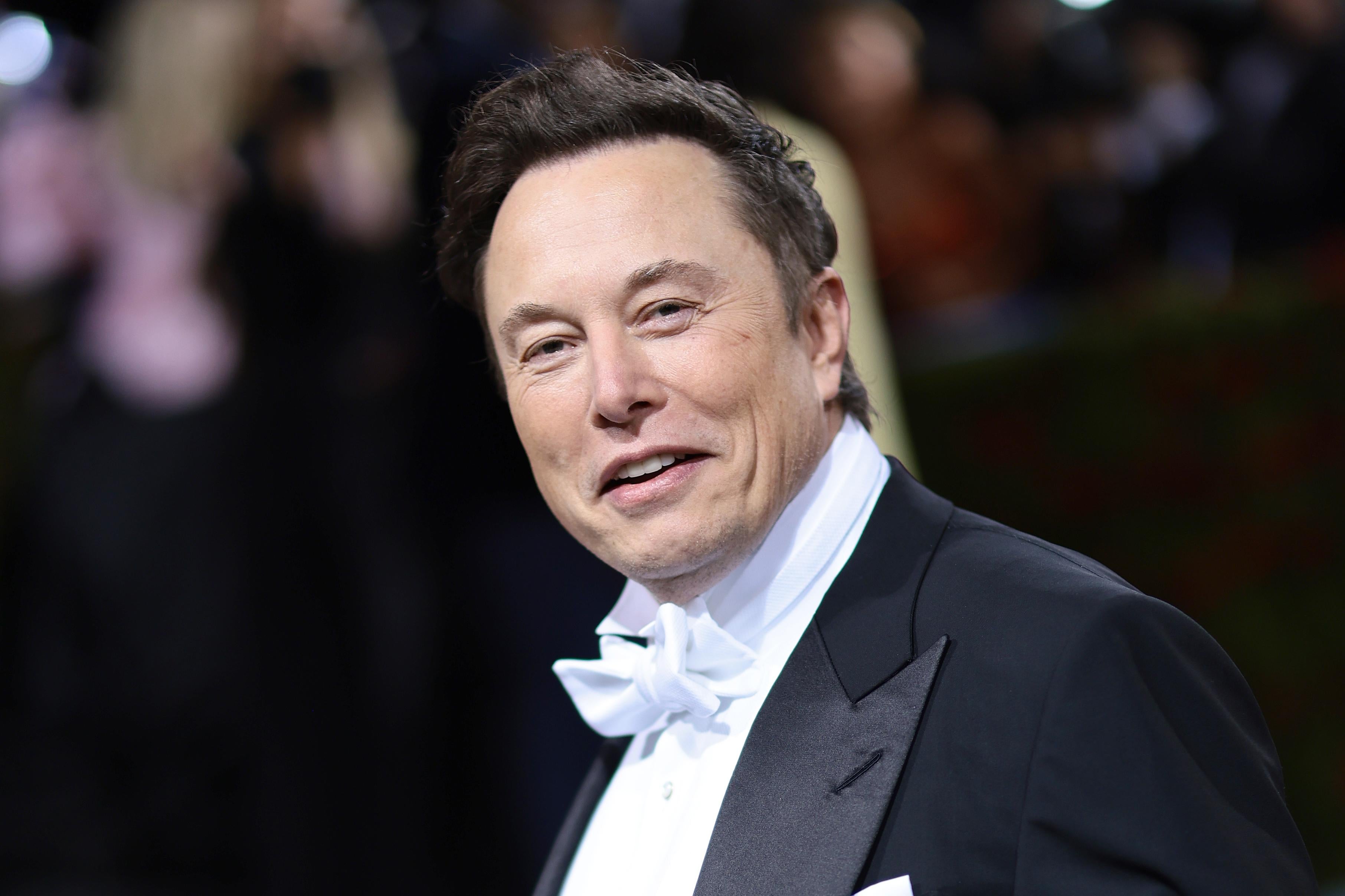 Elon Musk in a tux smiling at the Met Gala